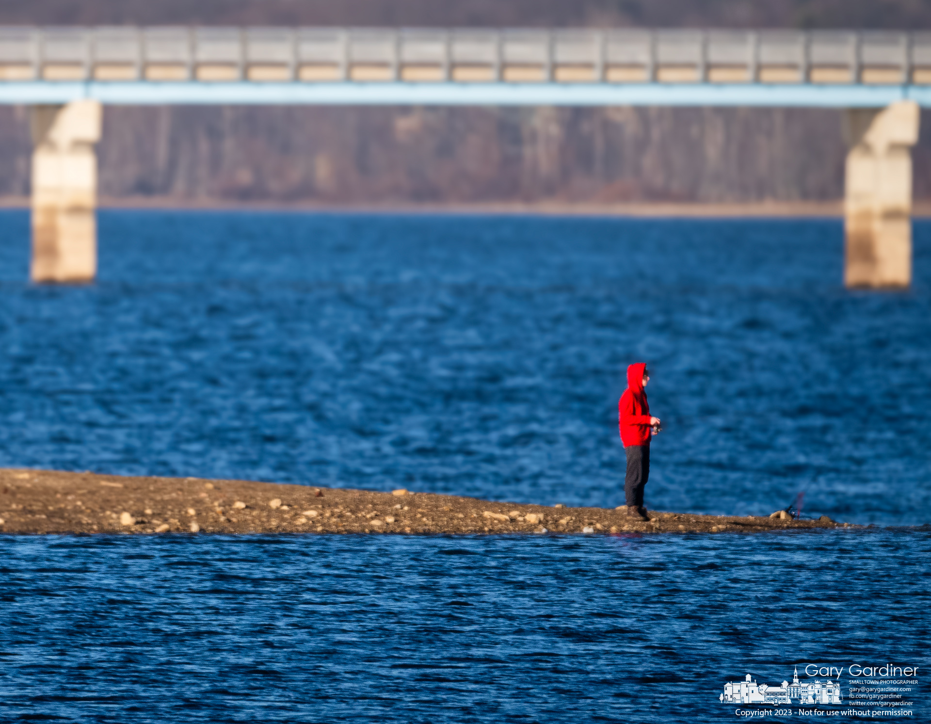 A lone fisherman stands on a narrow slice of land exposed by low water level at Hoover Reservoir. My Final Photo for December 20, 2023.
