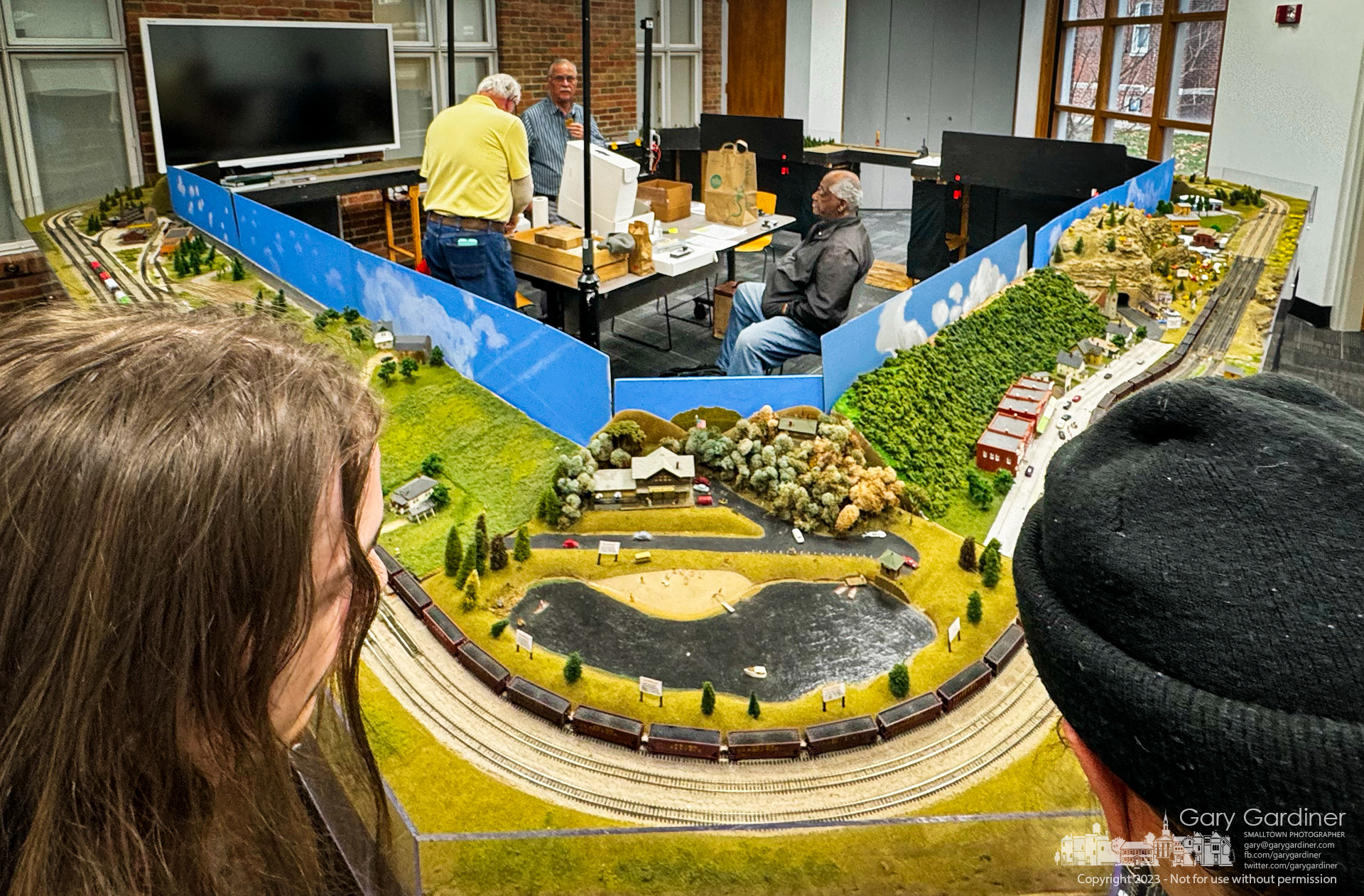 A pair of amateur model train enthusiasts watch "N" scale trains run their course in a room at the Westerville Public Library where the Columbus Area "N" Scalers set up its annual display. My Final Photo for December 8, 2023.