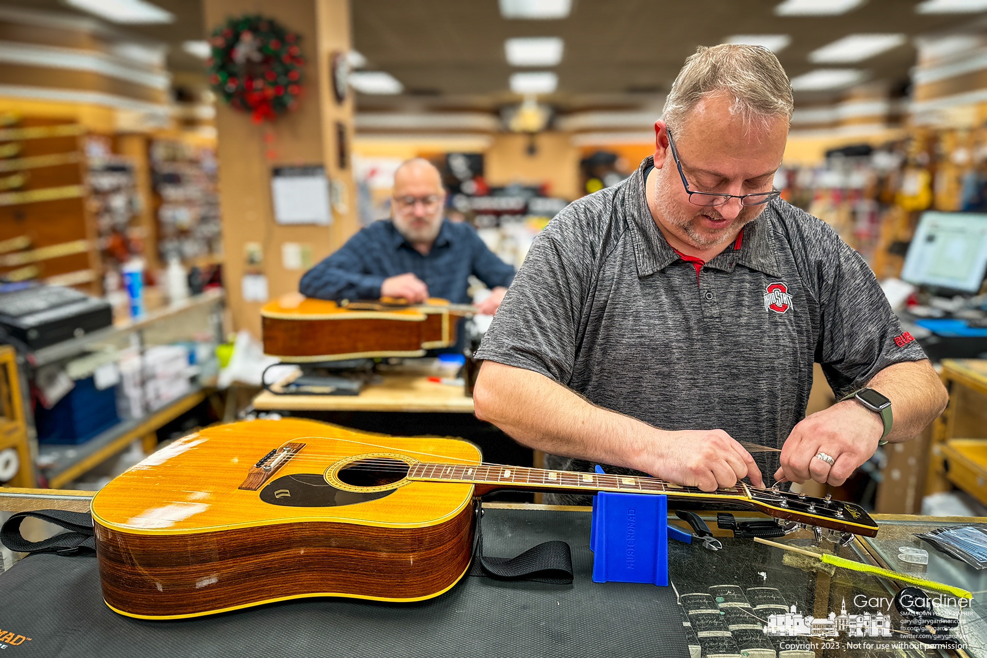 It's new strings and tuning for two guitars at Music and Arts in Uptown Westerville on a Friday evening. My Final Photo for December 29, 2023.