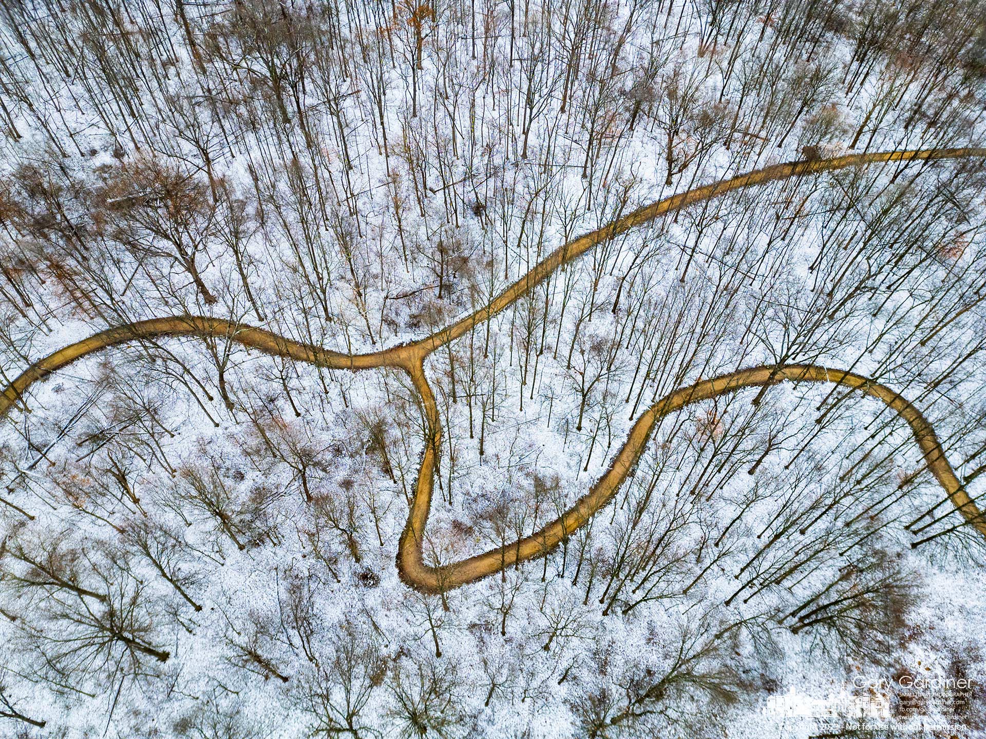 Paths forming the shape of a deer cross parts of snow-covered Sharon Woods a day after heavy squalls brought the first coating of snow for the season. My Final Photo for December 19, 2023.