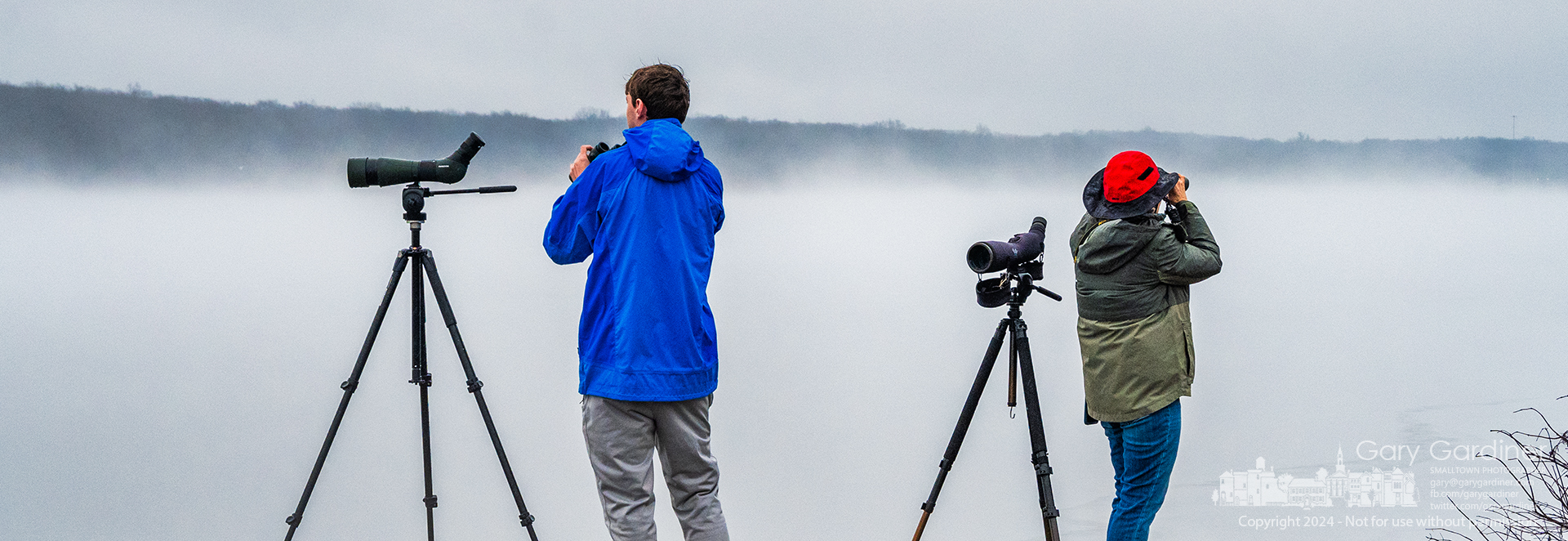 A pair of birders check in different directions through the afternoon fog across Hoover Reservoir. My Final Photo for January 24, 2024.