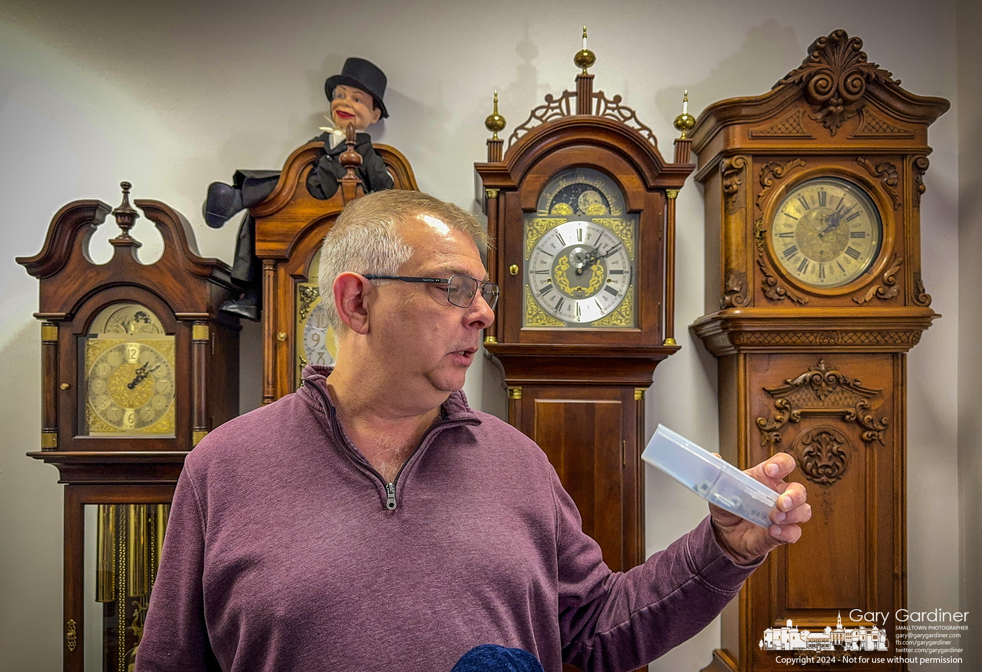 Grandfather Clock Company owner Jon Collins inspects a box of parts as he and his workers move their collection of clocks and the required repair parts into their new headquarters on South State Street from Uptown Westerville. My Final Photo for January 4, 2024.