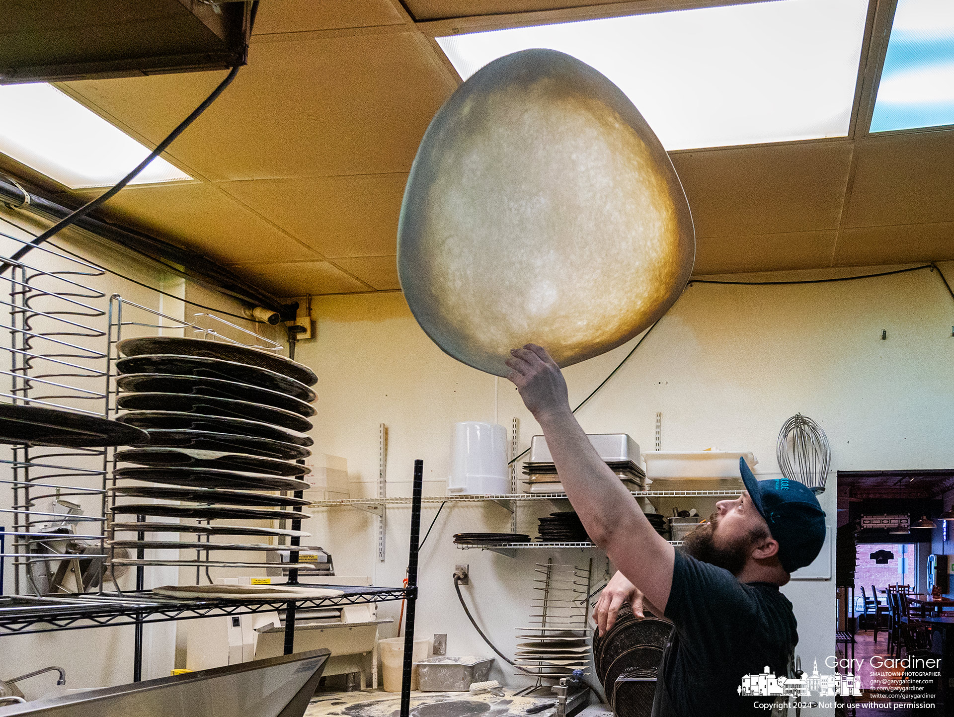 An extra-large thin-crust pizza dough gets tossed at Cardinal Pizza to make a double cheese pie on National Pizza Day. My Final Photo for February 9, 2024.