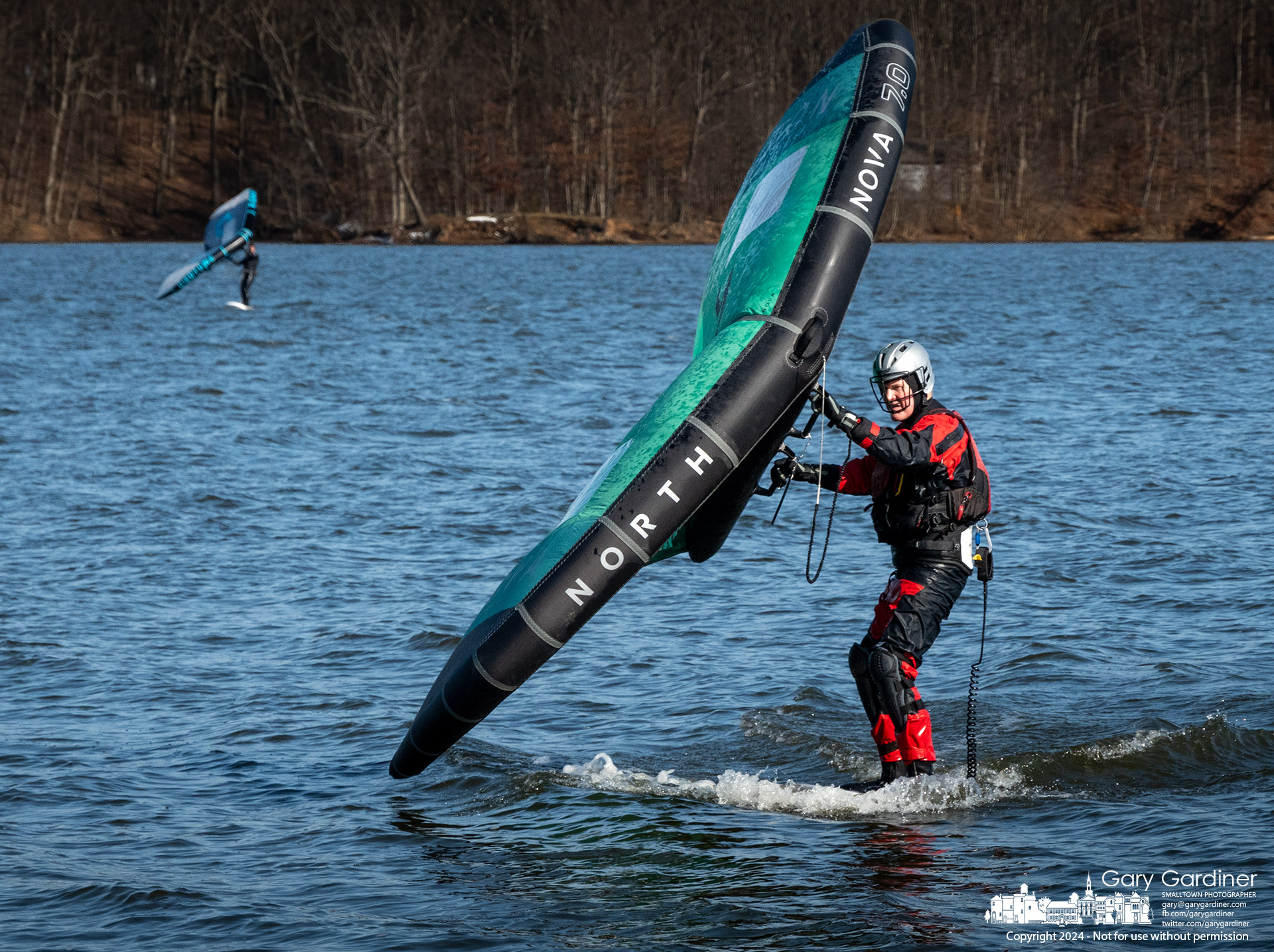 Foilboarder Jim Schneider works to lift his board onto its foil running into nearly 30 miles per hour wind gusts across Hoover Reservoir Sunday afternoon with other boarders. My Final Photo for February 25, 2024.