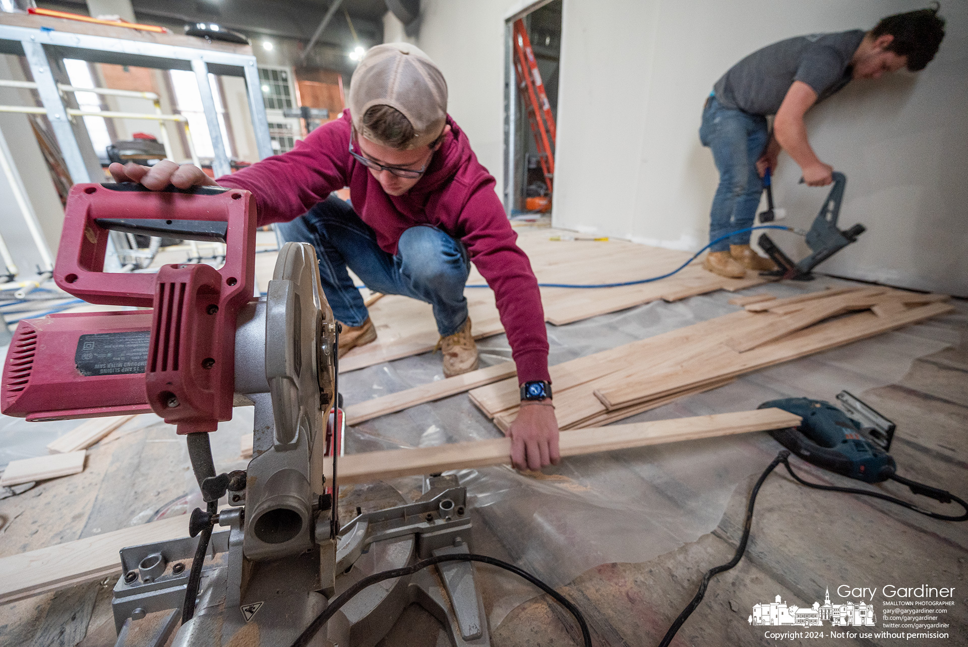 A flooring crew installs new tongue and groove maple strips to match the existing floor at High Bank Distillery in Uptown, which will be sanded and stained for a new durable surface. My Final Photo for February 28, 2024.