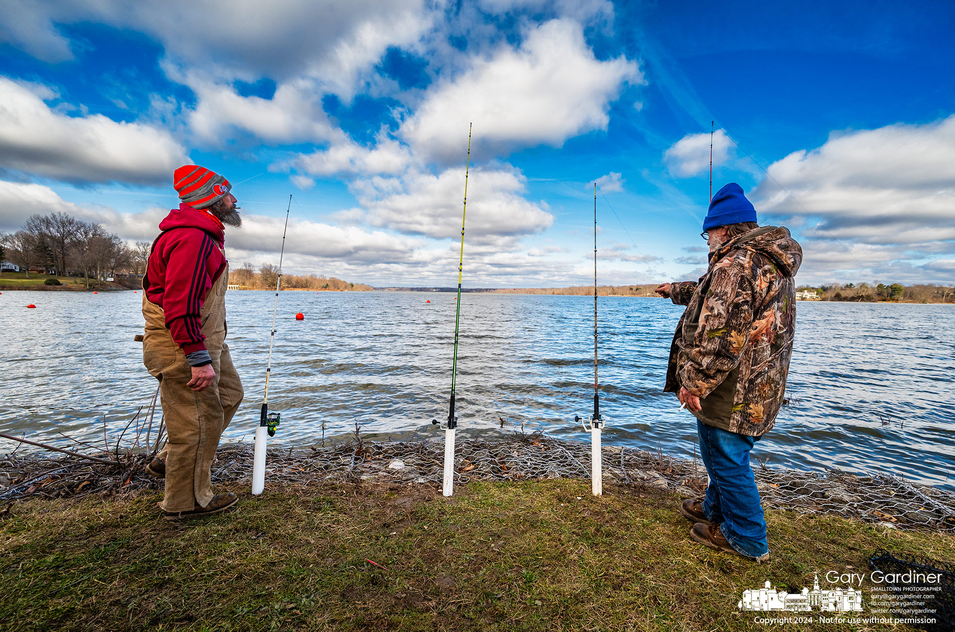 Jessie and Mark attend their rods with lines tossed into Hoover Reservoir in hopes of retrieving large catfish on a chilly and windy Friday afternoon.