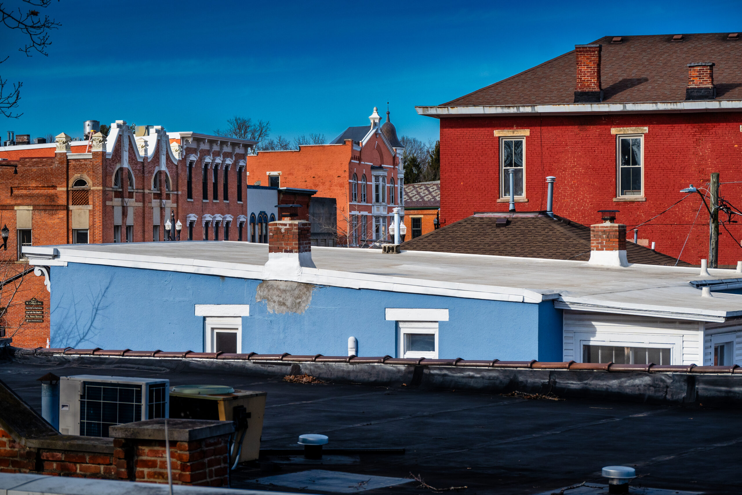 Rooftops and buildings in Uptown Westerville feel the warmth of the sun after several weeks of cold and wet weather. My Final Photo for February 1, 2024.