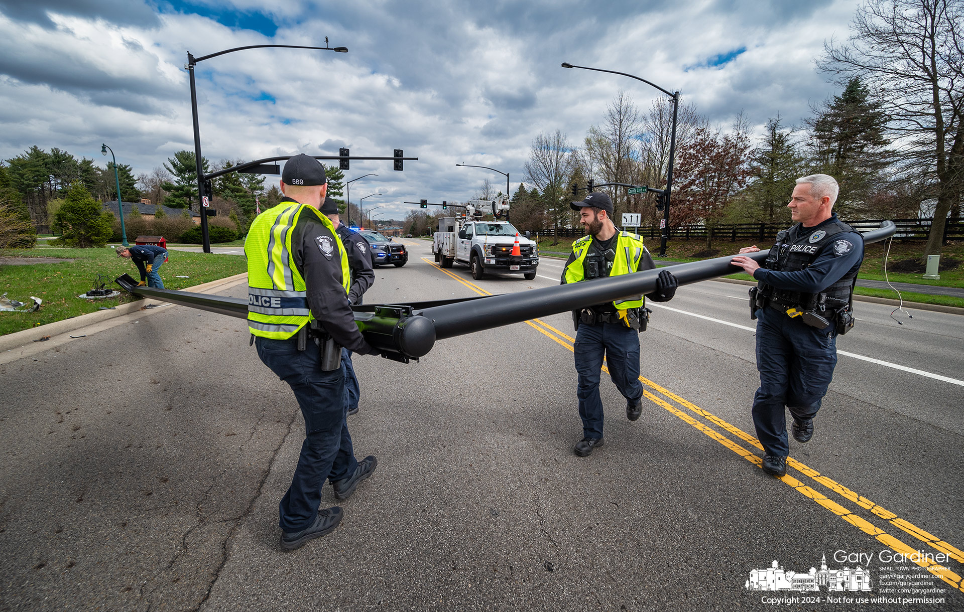 Westerville police officers removed a downed light pole after a car crash at West County Line Road and Vesper Way Sunday afternoon. My Final Photo for March 17, 2024.