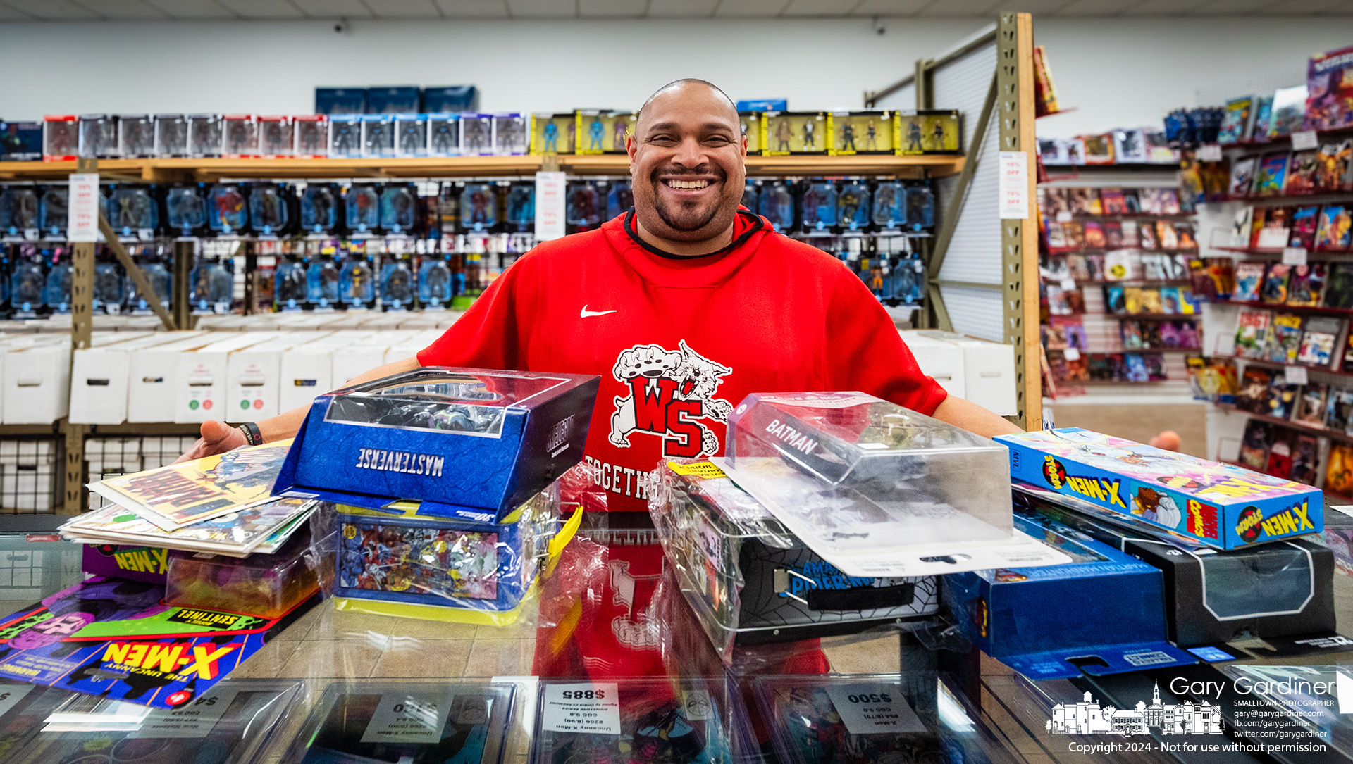 Jerome Rogers shows off the comic books, action figures, and lunch boxes he bought at World's Greatest Comics 13th Anniversary Sale Saturday in Glengary Center. My Final Photo for March 9, 2024. 