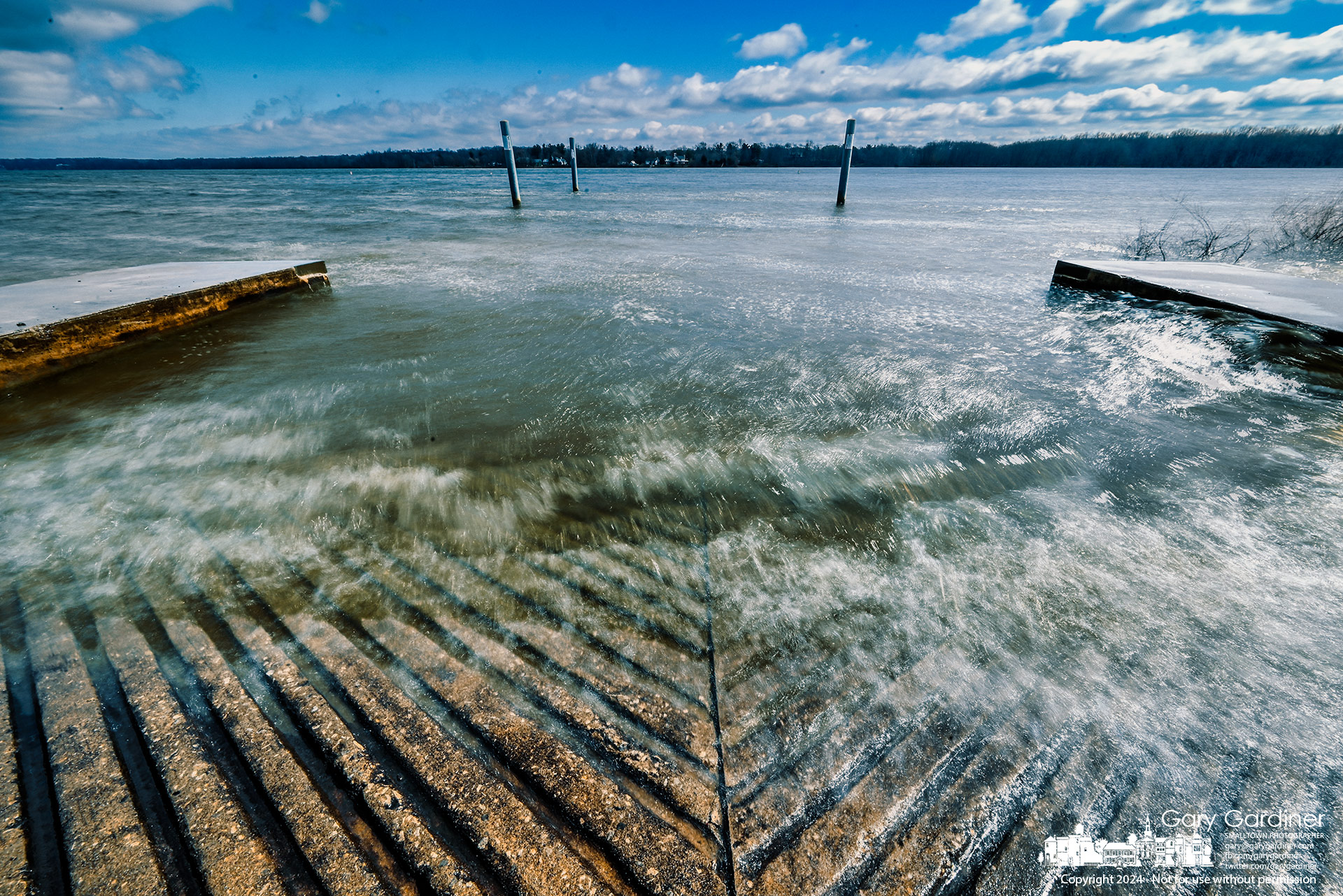Strong northerly winds create whitecaps across Hoover Reservoir and push the high waters onto the boat ramp at Red Bank Park on Saturday afternoon. My Final Photo for March 23, 2024.