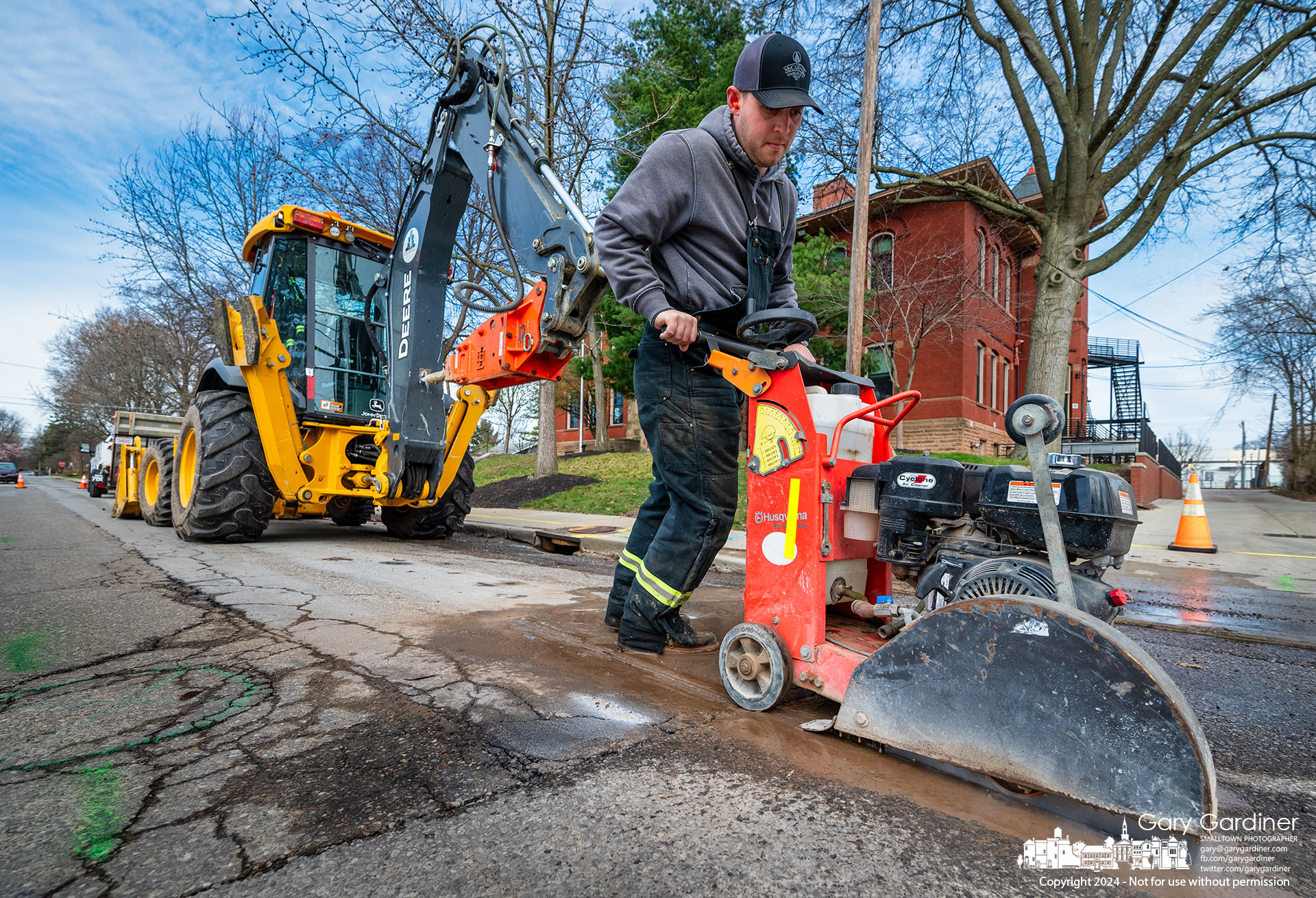 After the school closed Tuesday, a section of the street in front of Emerson Elementary was removed to make water pipe repairs. The leak was discovered just before school began but repairs were delayed so as not to disrupt student drop-off and pickup. My Final Photo for March 19, 2024.