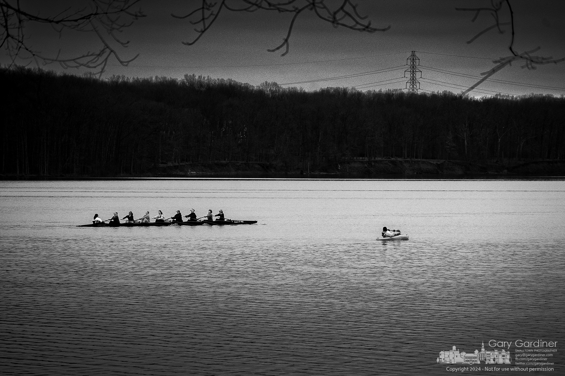 A kayaker steers away from a rapidly approaching Westerville Crew rowing boat practicing with other boas at Hoover Reservoir. My Final Photo for March 7, 2024.