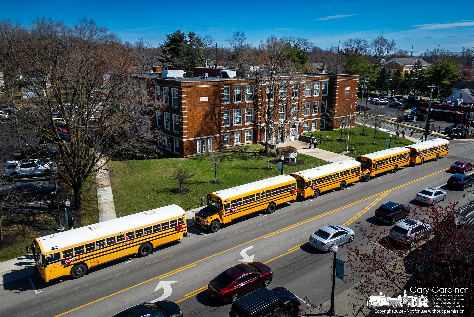 Buses line up in front of Hanby Elementary on State Street preparing to ferry students home after school on Thursday. My Final Photo for March 21, 2024.
