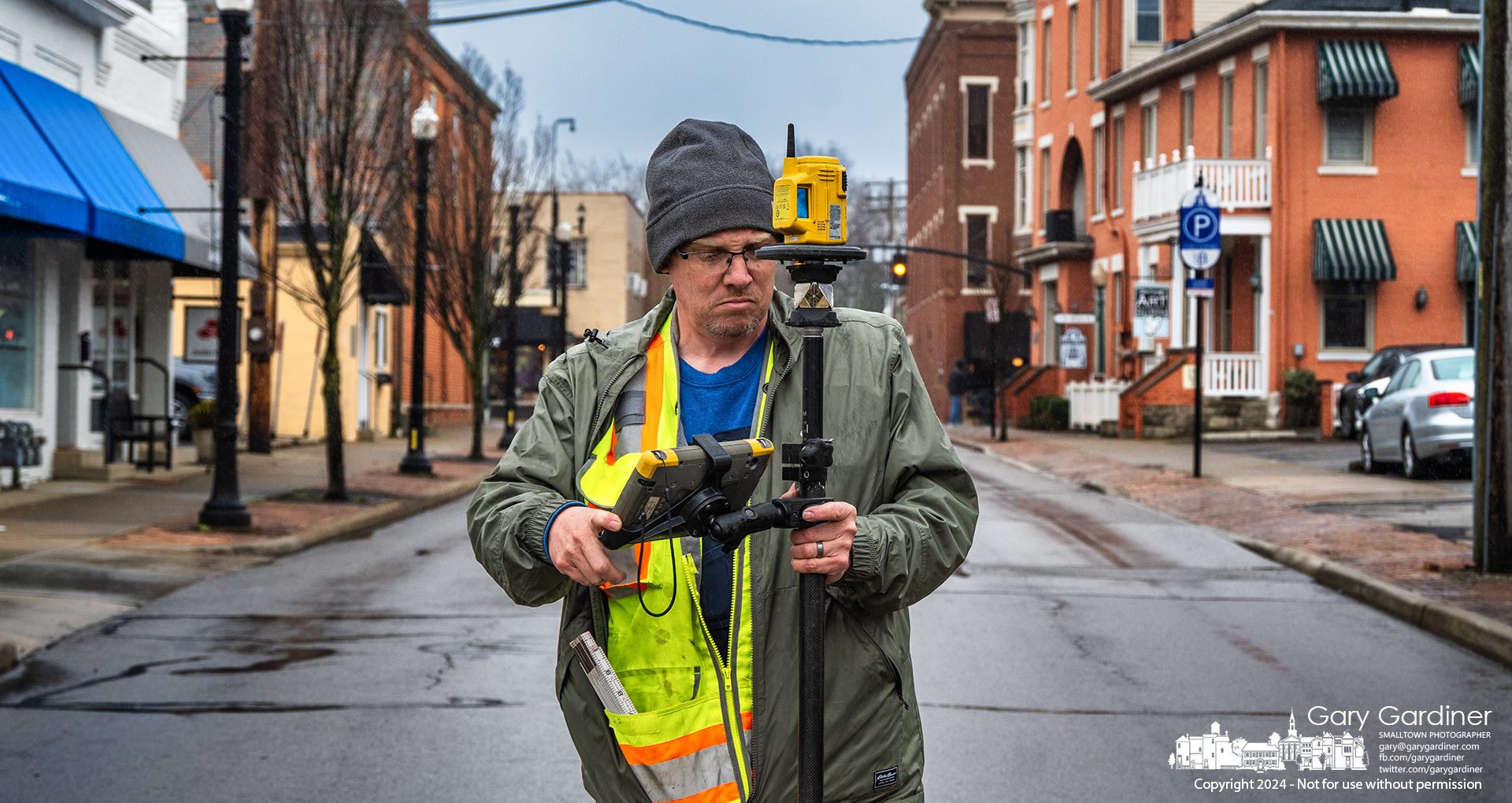 Surveyor Matt Preston measures elevations and locations along West Main Street for the city which plans to lay new water mains in Uptown. My Final Photo for March 6, 2024