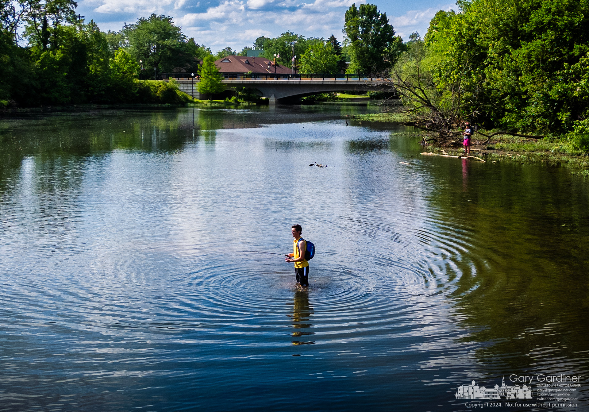 A young fisherman wades into the slow waters of Alum Creek just downstream from the Main Street Bridge to find the perfect placement for his bait as he and his friends on shore enjoy the warm afternoon. My Final Photo for May 25, 2024.