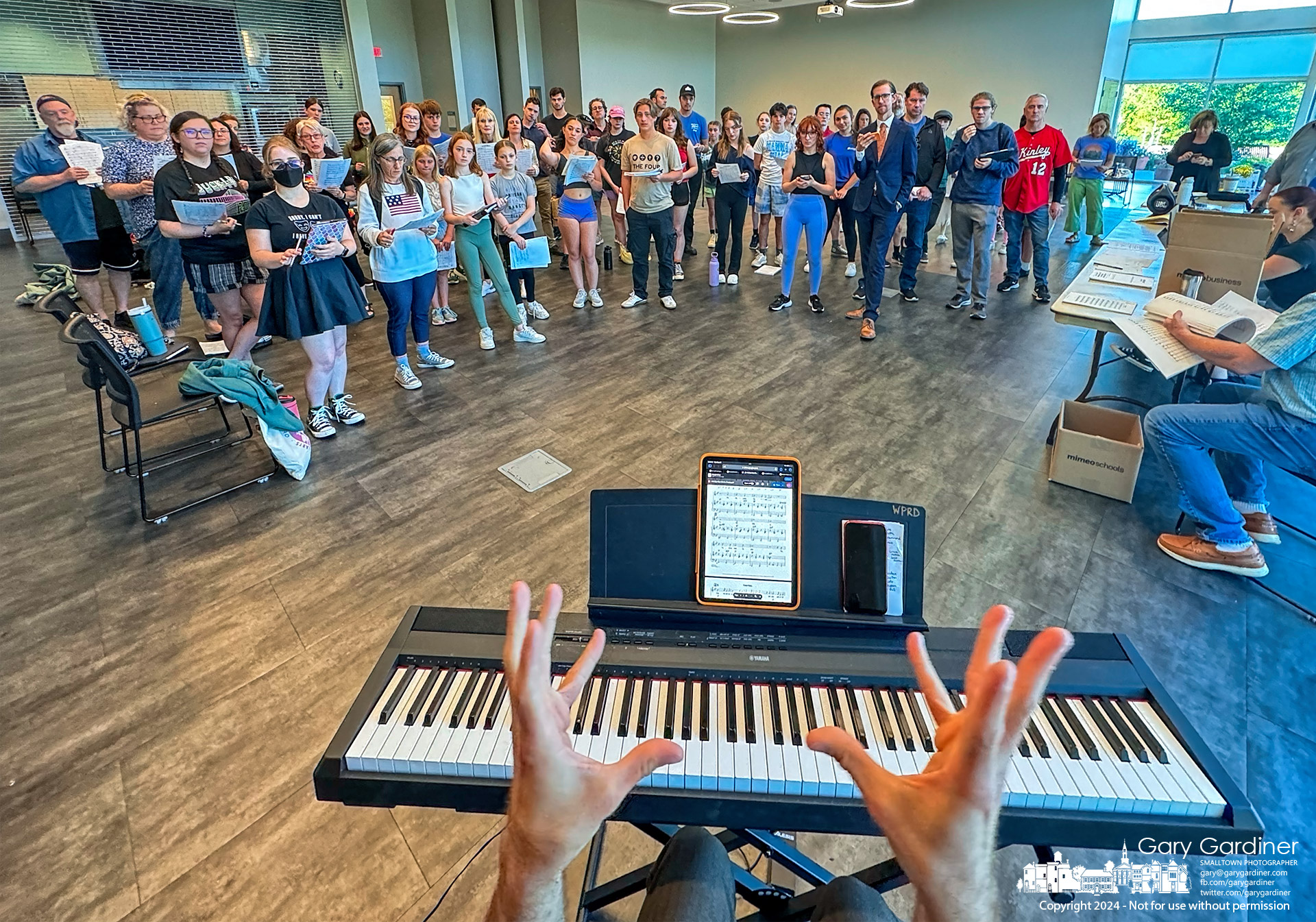 The music director for the Westerville Civic Theater's production of Bye Bye Birdie uses expressive hand gestures to instruct the cast of Bye Bye Birdie during rehearsals Thursday night at the community center. My Final Photo for May 30, 2024.