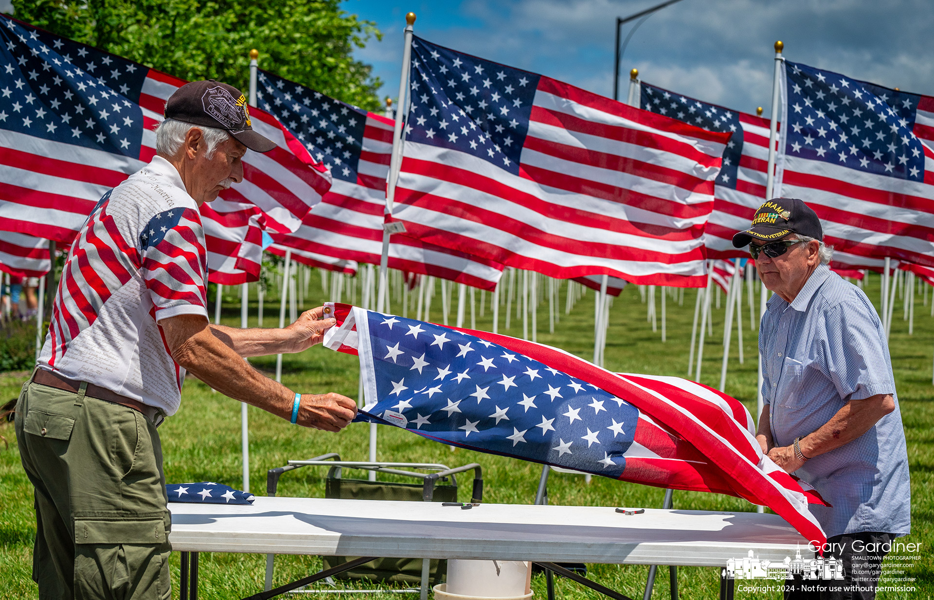 Volunteers perform the proper 13-fold of flags removed from the Westerville Field of Heroes by the people who purchased them in honor of family and friends in the military. My final Photo for May 27, 2024.