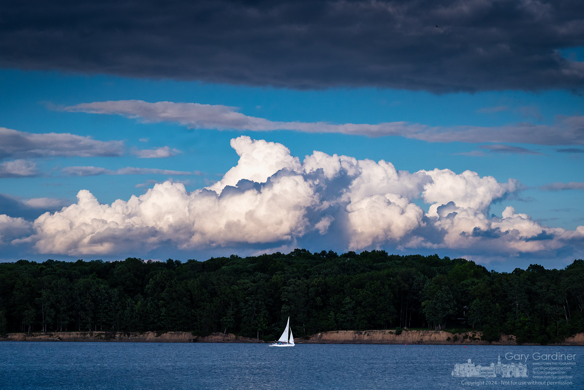 A lone sailboat runs against the wind on Hoover Reservoir late in the afternoon with the threat of heavy storms on the horizon. My Final Photo for May 28, 2024.