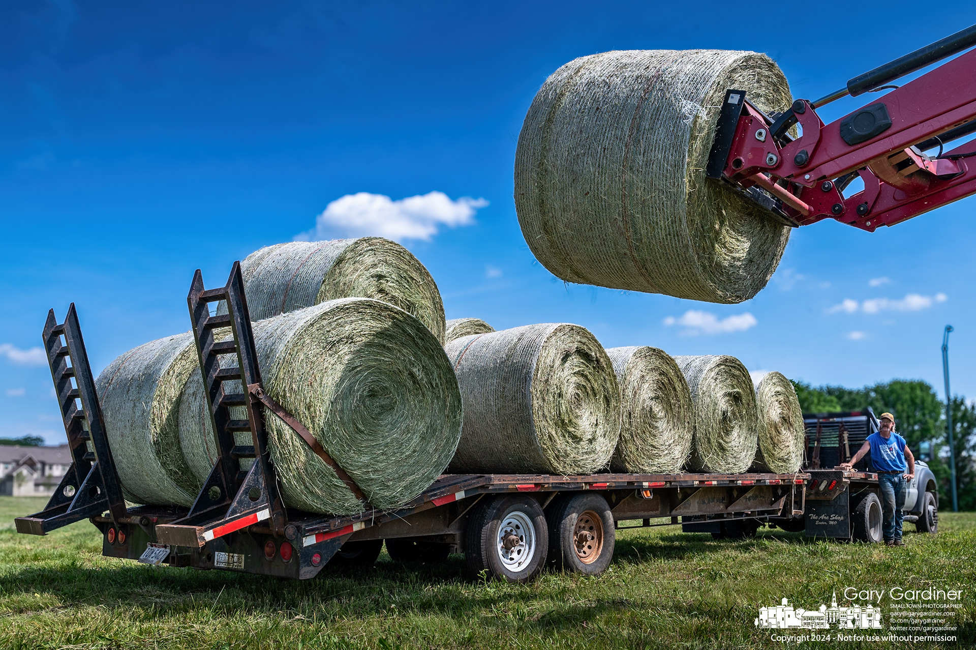 The last round hay bales harvested from the Otterbein field on Cooper Road is loaded onto a trailer to be put in barn storage for feeding cattle. My Final Photo for May 20, 2024.
