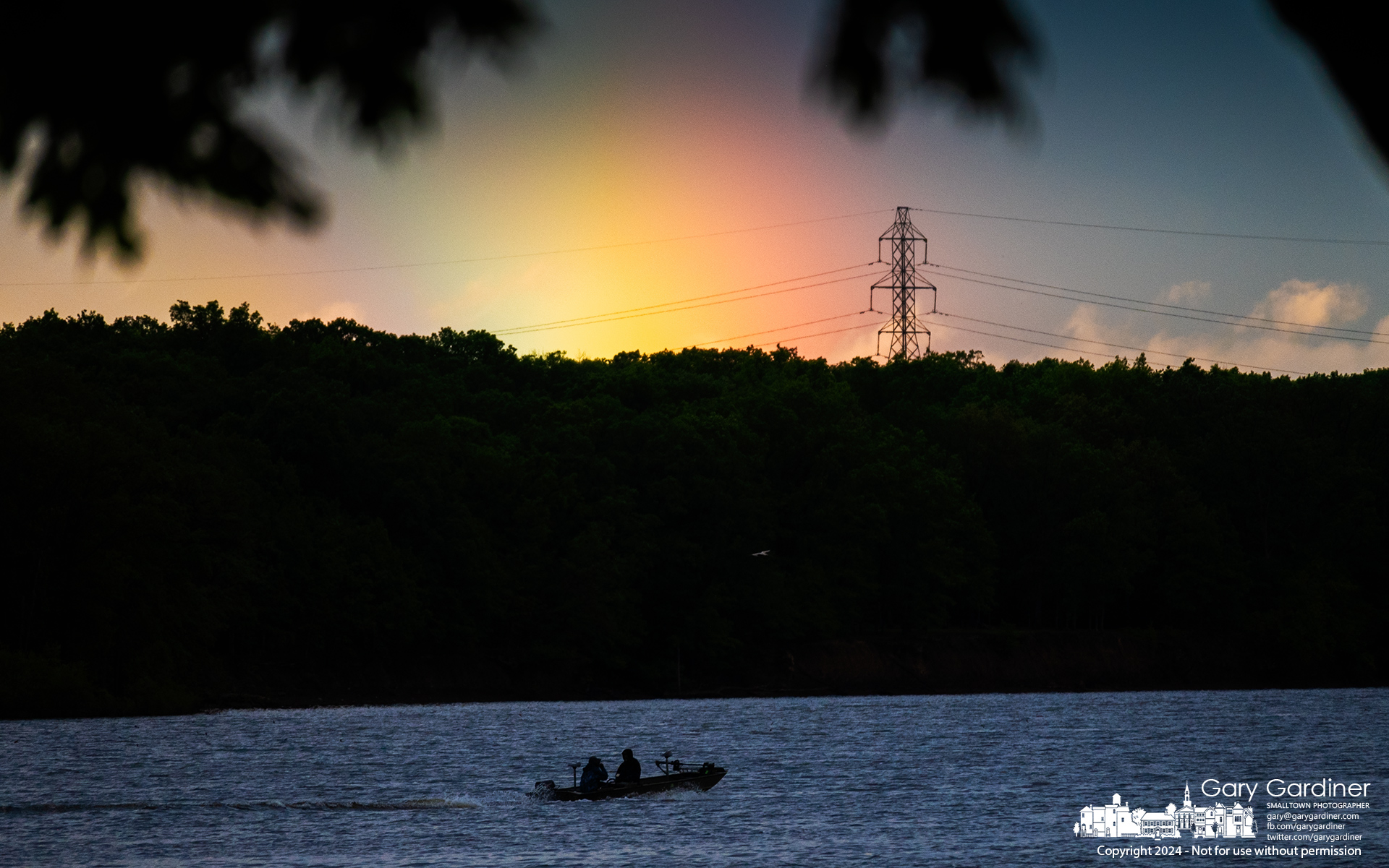 After late afternoon storms, a pair of fishermen return to the docks at Hoover Reservoir under the umbrella of a rainbow in the eastern sky. My Final Photo for May 9, 2024.