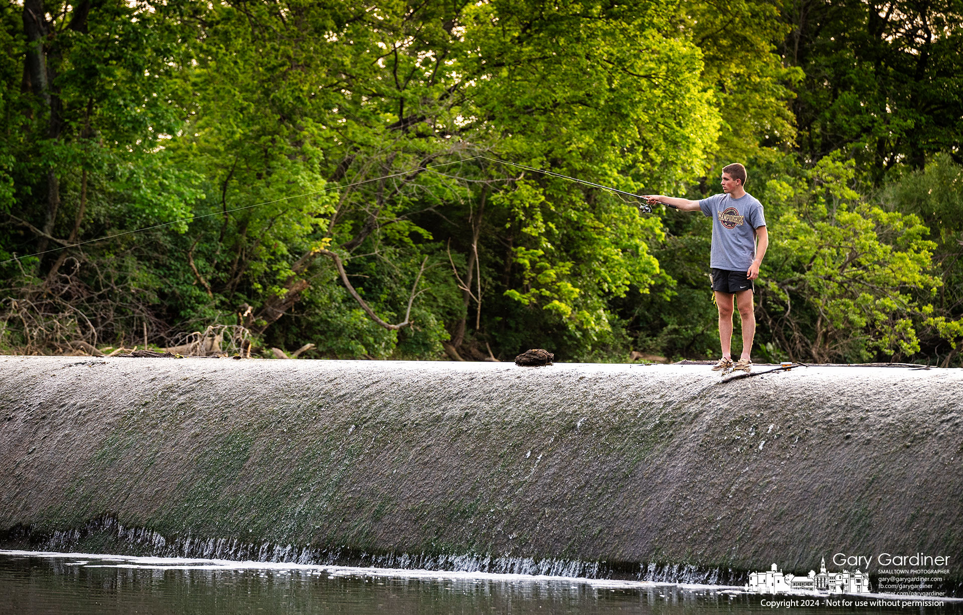 Sam Eckard casts his from atop the Alum Creek low-head dam into the pool of water below hoping his luck is better than what he had on the shoreline. My Final Photo for May 31, 2024.