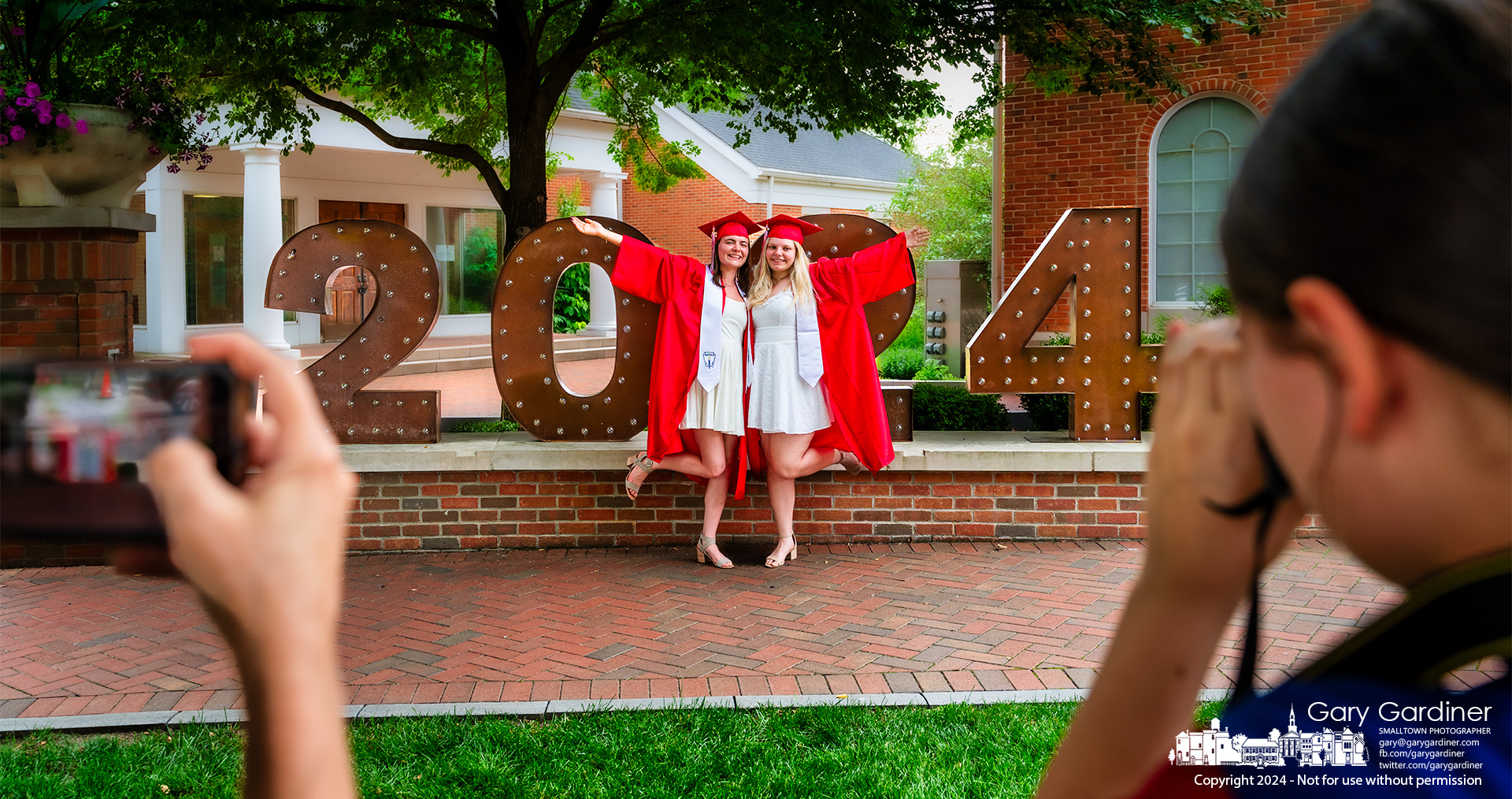 Westerville South graduates Melania Randall, left, and Sophia Parimuha pose for photos in front of the 2024 display at city hall. My Final Photo for May 23, 2024.
