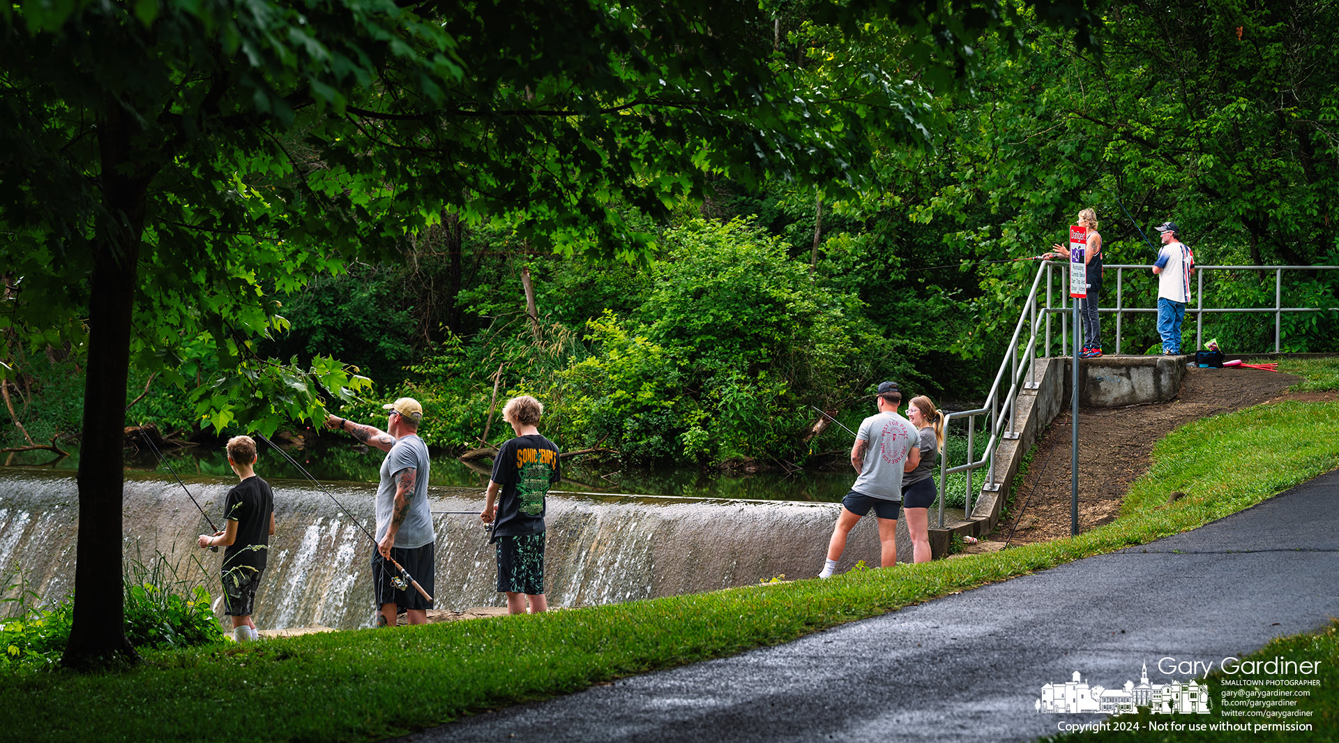 Seven fishing hopefuls line up along the short section of retaining wall below the dam at Alum Creek North, hoping their spot is the best location for the big one in the shallow waterways. My Final Photo for June 5, 2024.