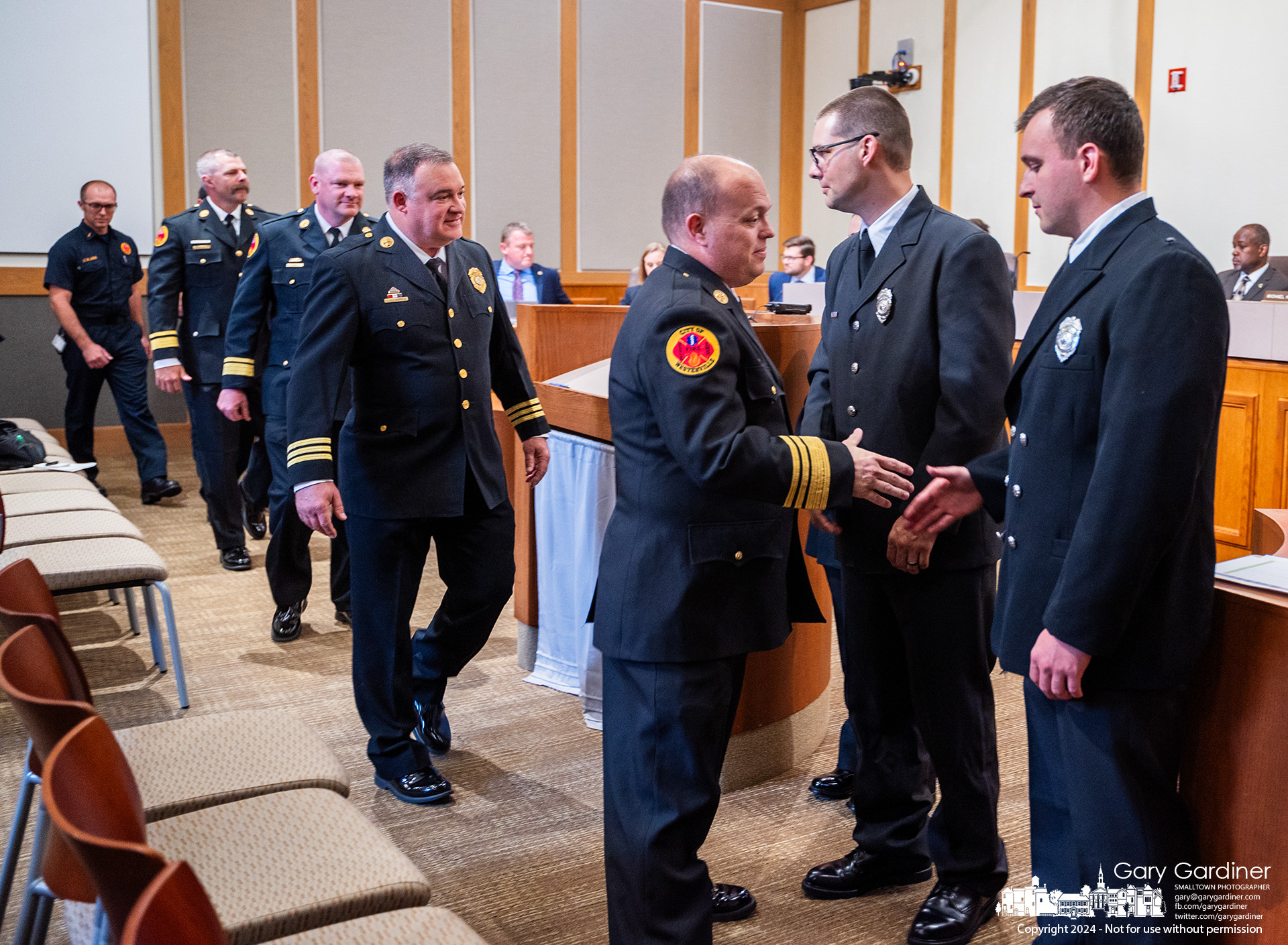 Westerville Fire Chief Brian Miller, trailed by other members of the fire department, shakes hands with the three firefighters sworn-in at the beginning of City Council Tuesday night. My Final Photo for June 4, 2024.