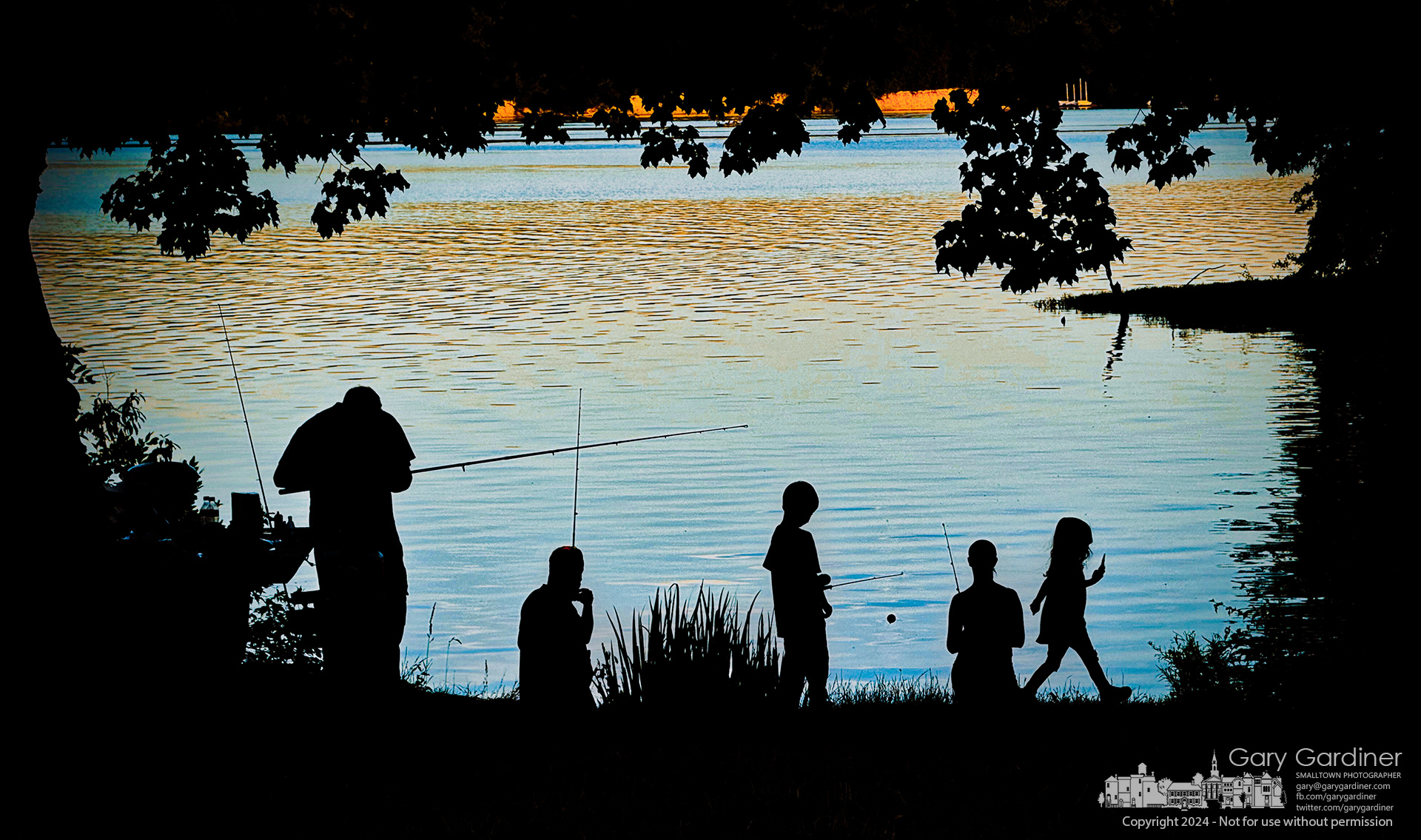A family fishes from the shade along the shoreline at red Bank Park on Hoover Reservoir on a windless, warm Saturday afternoon. My Final Photo for June 15, 2024.