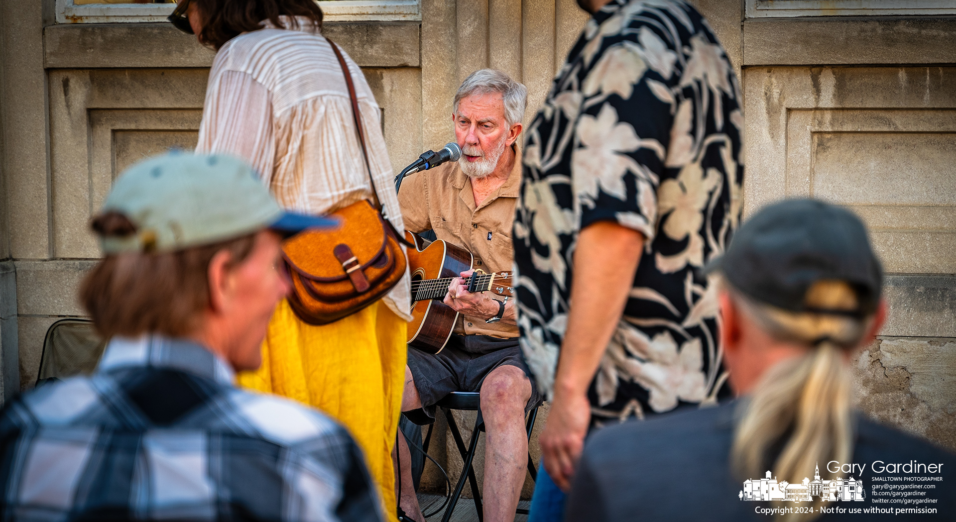 Musician Bob May accompanies himself on guitar while singing on the sidewalk in front of Middlefield Bank during Uptown Friday Night's music concerts. My Final Photo for July 5, 2024.