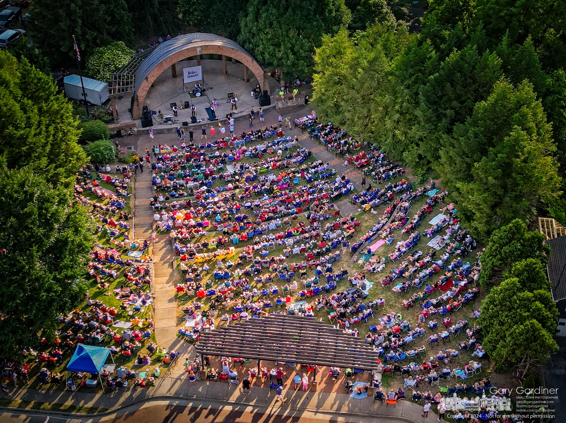 An overflow crowd gathers at the Alum Creek Amphitheater to hear the British Invasion band's annual Summer Concert in the park. My Final Photo for July 21, 2024.