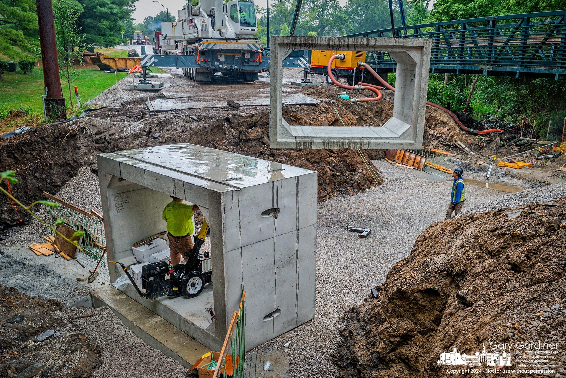 A section of preformed concrete culvert is lowered into place on Hempstead Road, replacing a much older decayed culvert. My Final Photo for July 22, 2024.