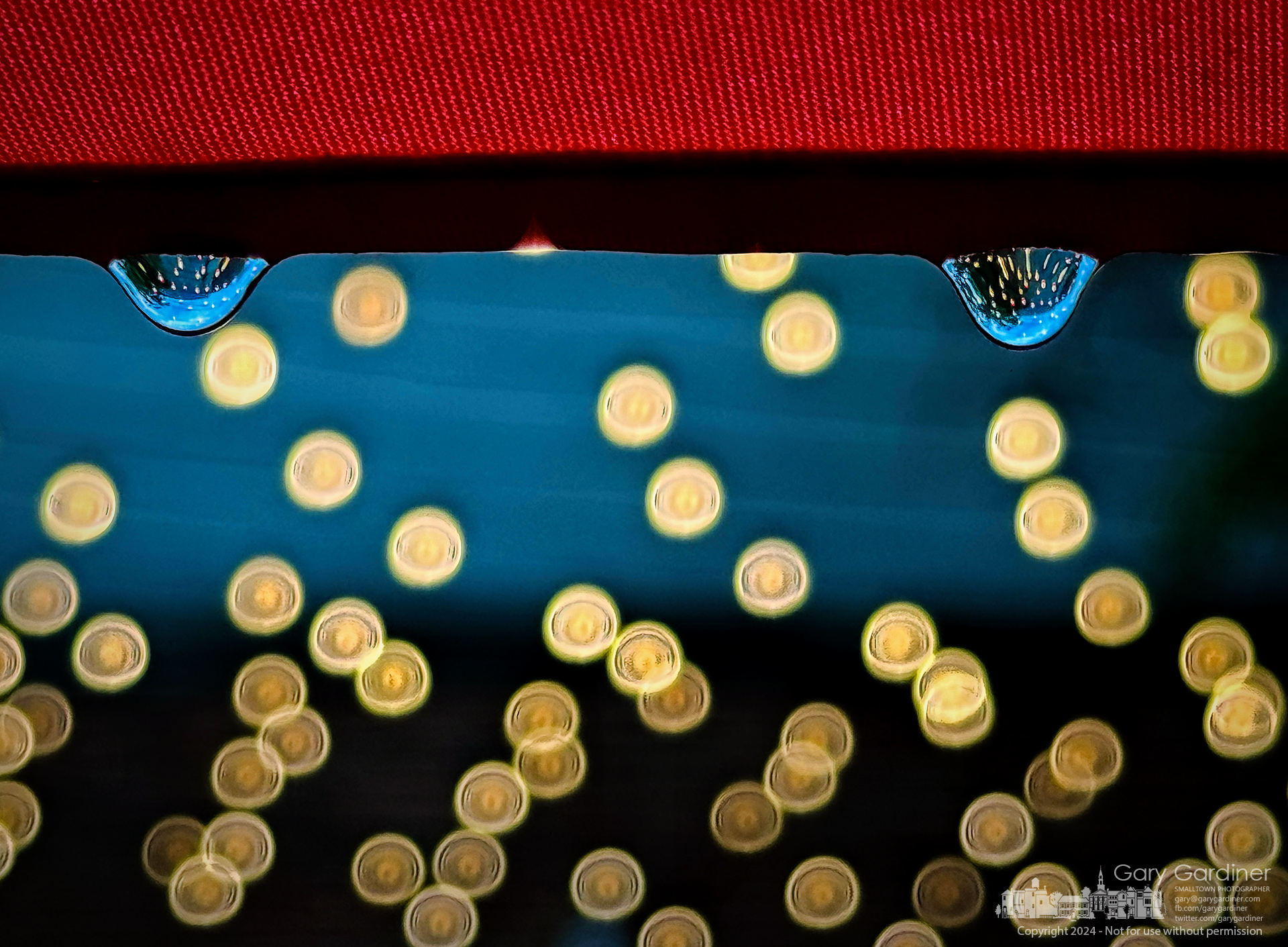 The LED lights on the patio at Jimmy V's are refracted in raindrops falling from umbrellas on the patio after a brief rainstorm. My Final Photo for June 3, 2024.