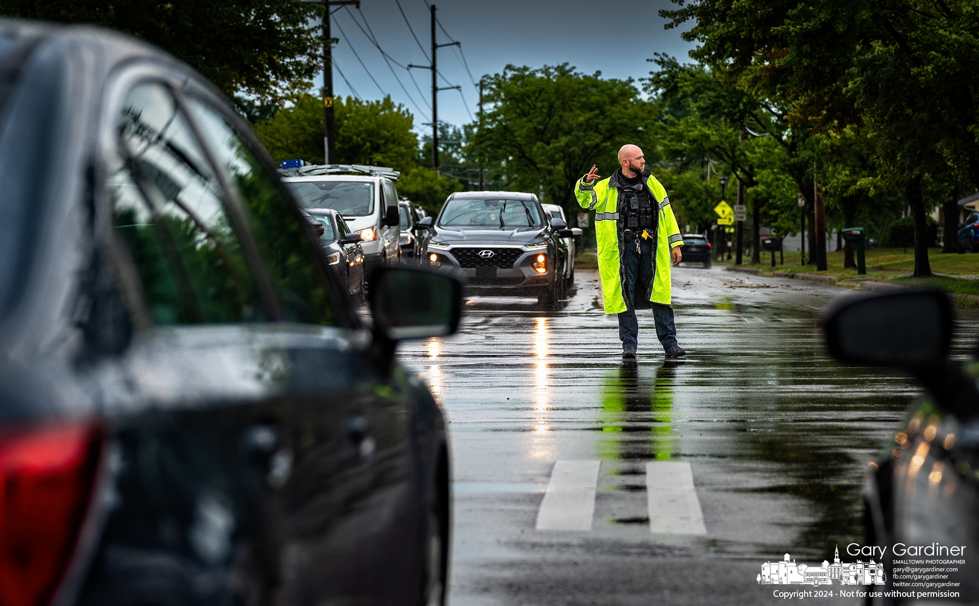 A Westerville police officer directs traffic at County Line Road and North Spring after a brief but violent afternoon storm knocked out power to sections of the city. My Final Photo for July 17, 2024.