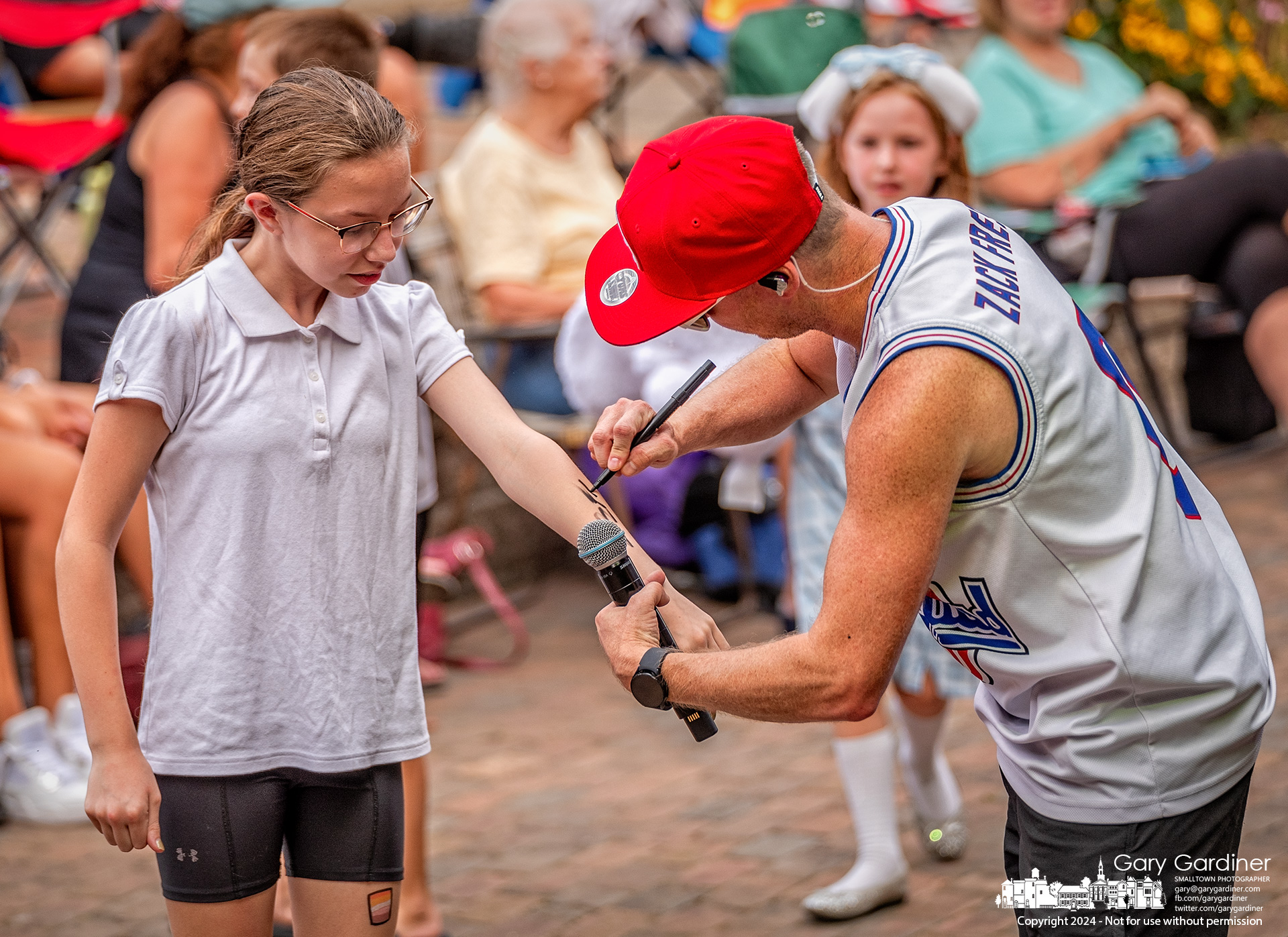 "Zack Fresh," the lead singer for "Zack Attack," signs an autograph for a fan during the rock band's performance as part of the Sunday Concert Series at Alum Creek Amphitheater. My Final Photo for July 28, 2024.