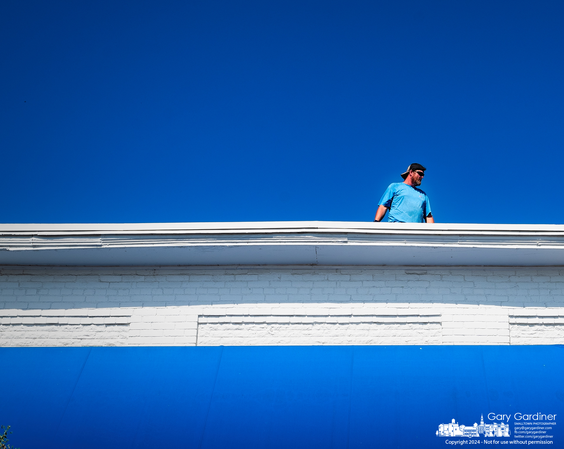 An inspector walks the edge of a roof on a building in Uptown Westerville as part of a routine check of the structure. My Final Photo for September 16, 2024.