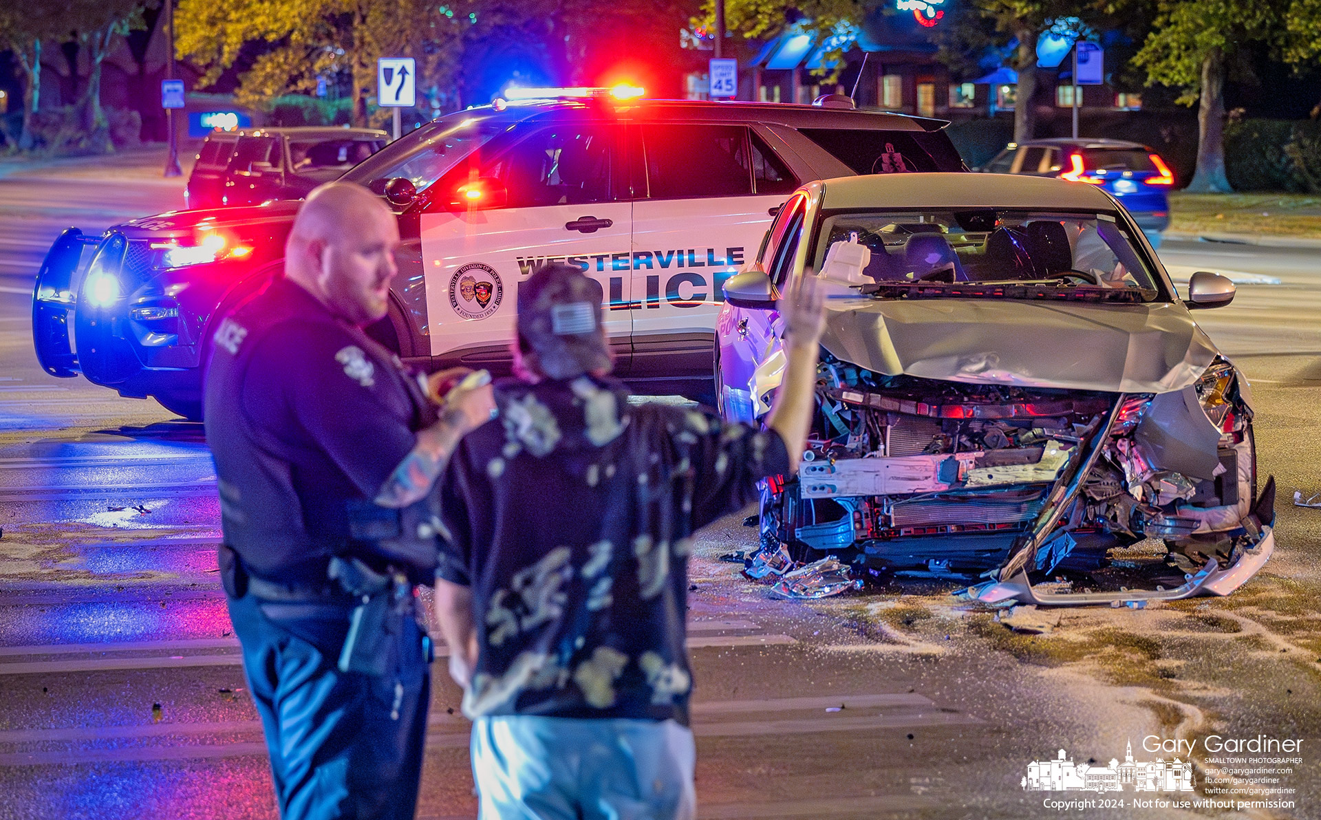 A Westerville police officer talks with a driver in a four-car crash without injuries at Maxtown and North State Street Tuesday night. My Final Photo for September 17, 2024.