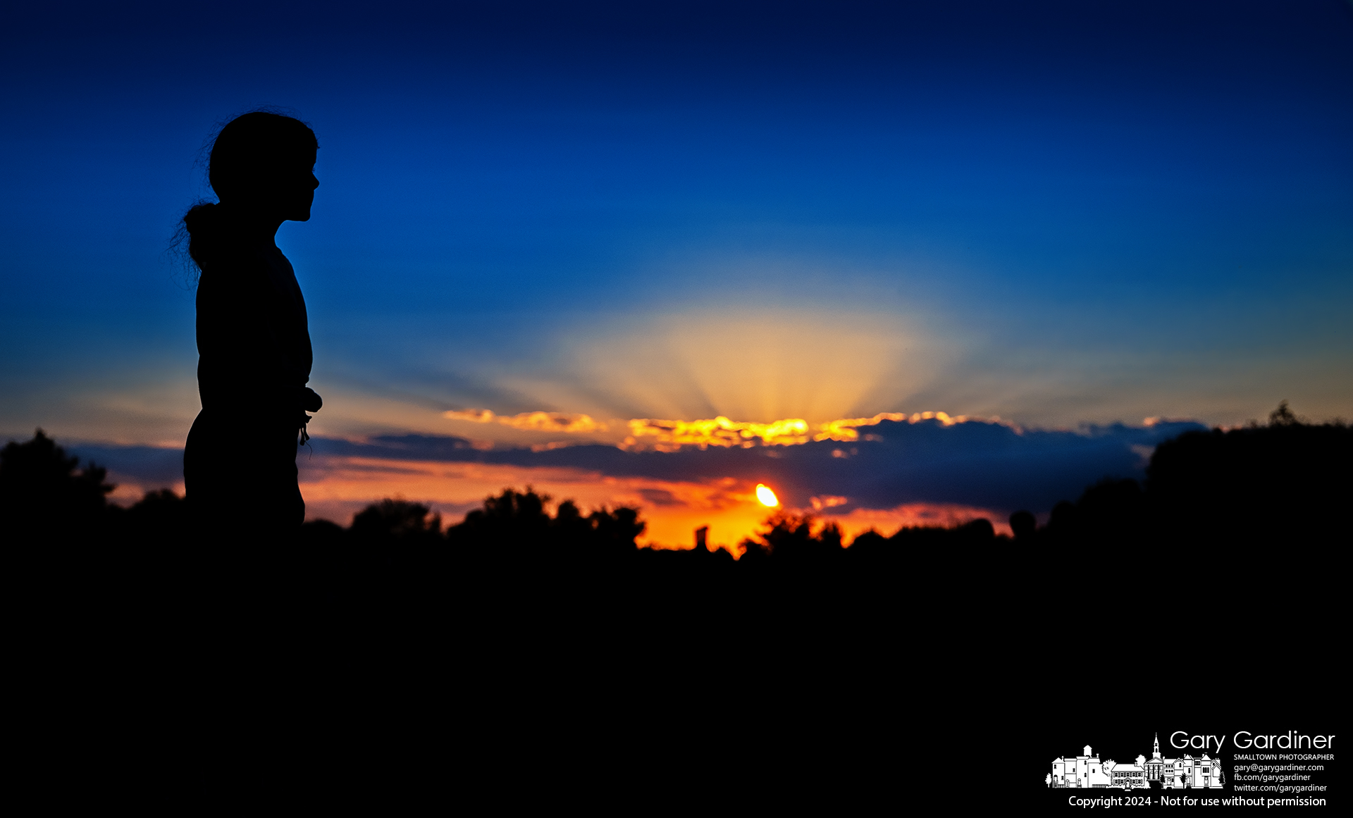 A St. Paul School cross country runner stands silhouetted against the sunset as the team completes an abbreviated practice the day after a competition. My Final Photo for September 5, 2024.