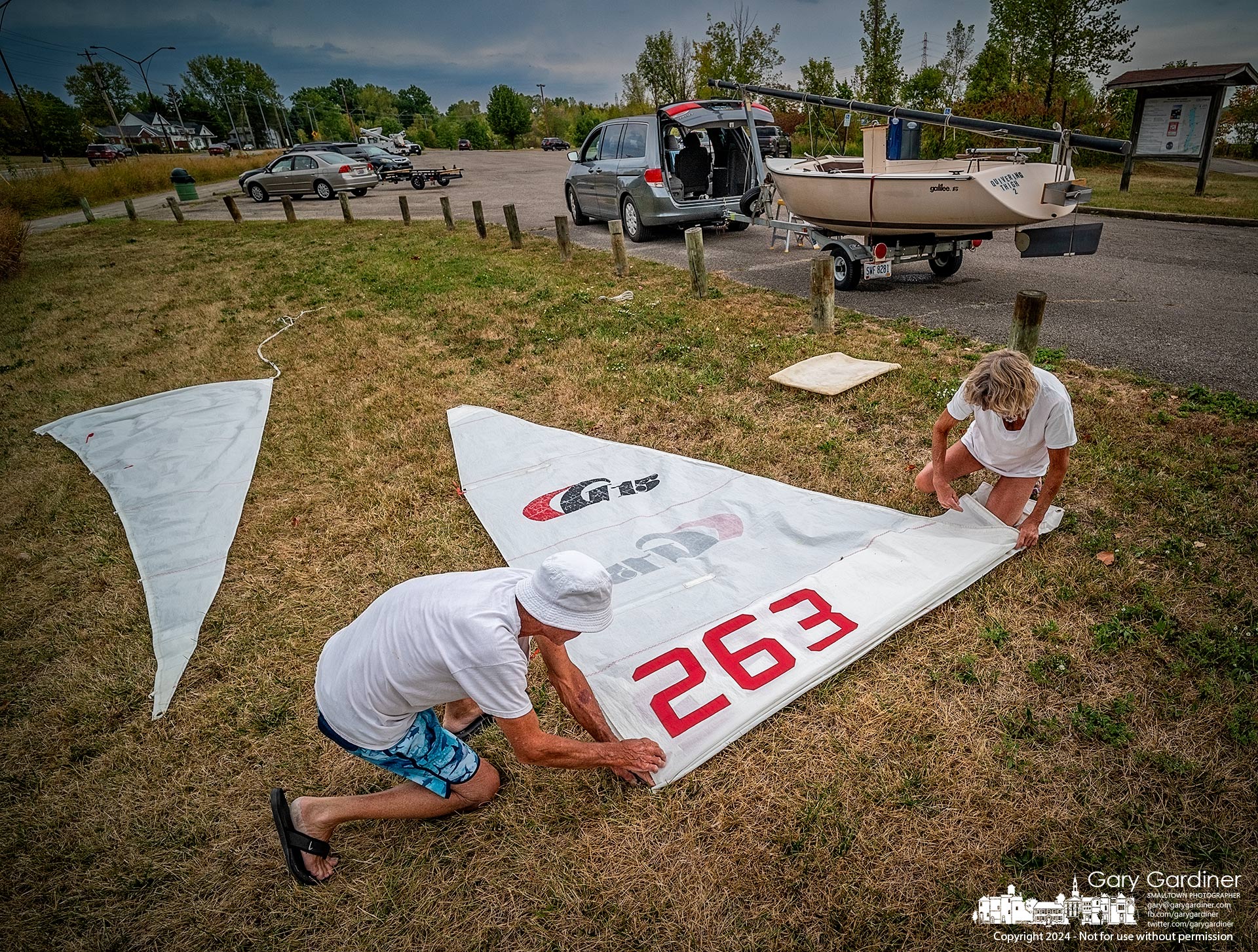 Brother and sister sailors store their mainsail after a day sailing across the waters of Hoover Reservoir. My Final Photo for September 22, 2024.