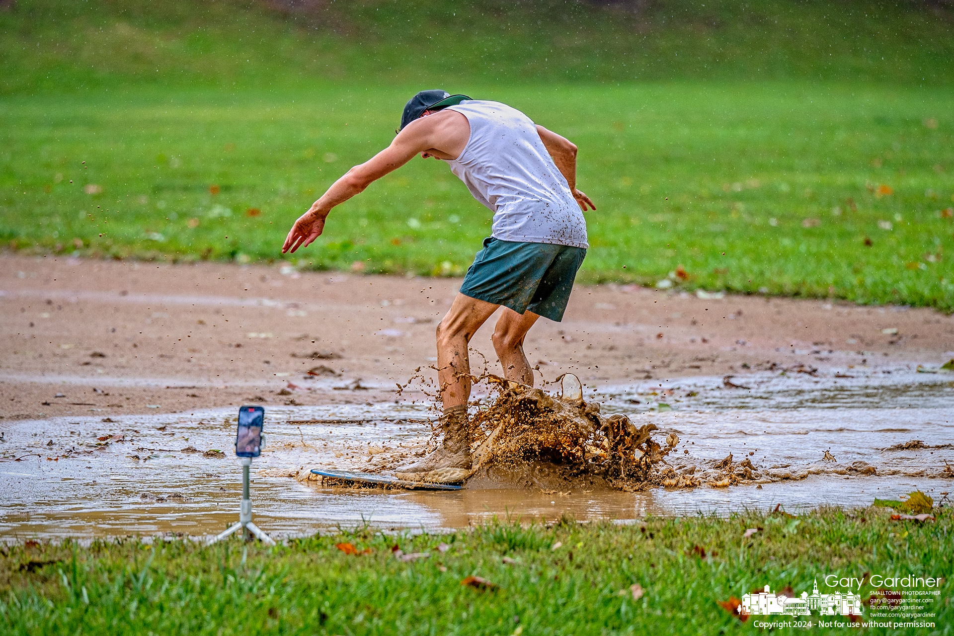 Jesse Allman records himself rideing a skimboard across a puddle in the infield at the baseball field in Alum Creek Park North. My Final Photo for September 29, 2024. 