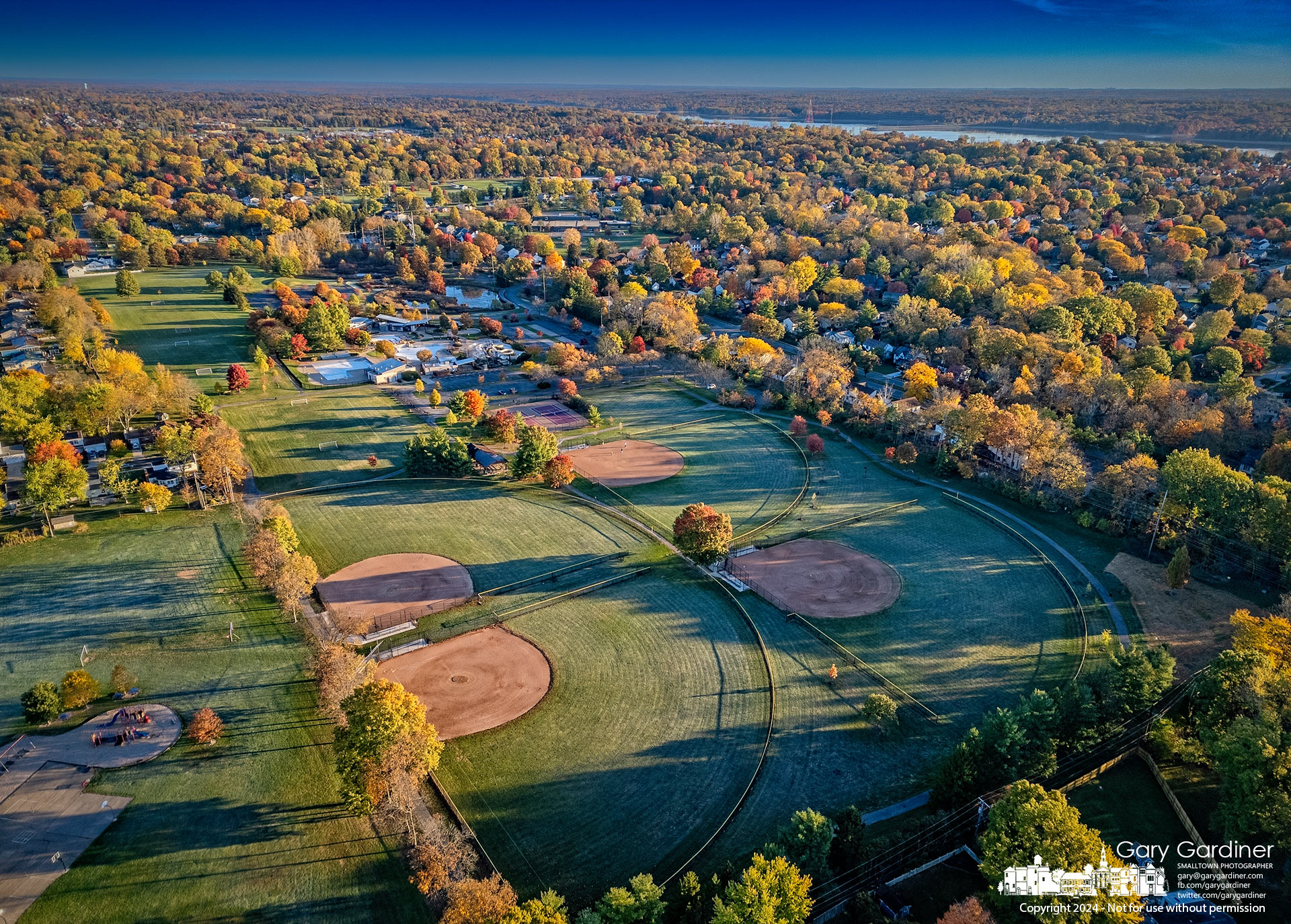 Sunrise brightens the morning across the fields at Highlands Park and the surrounding neighborhood with Hoover Reservoir as a backdrop. My Final Photo for October 27, 2024.