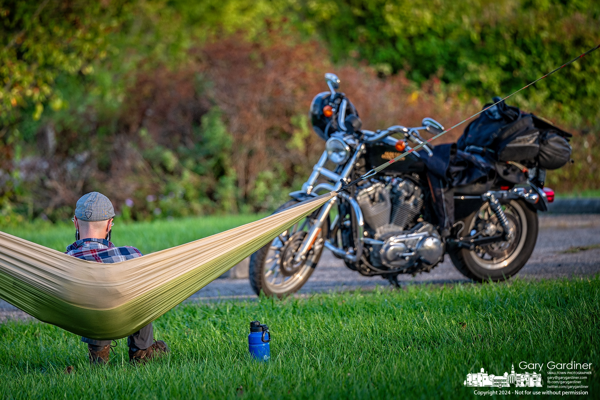 A motorcyclist relaxes in his hammock stretched between trees at the Walnut Street boat ramp entrance at Hoover Reservoir. My Final Photo for October 4, 2024.