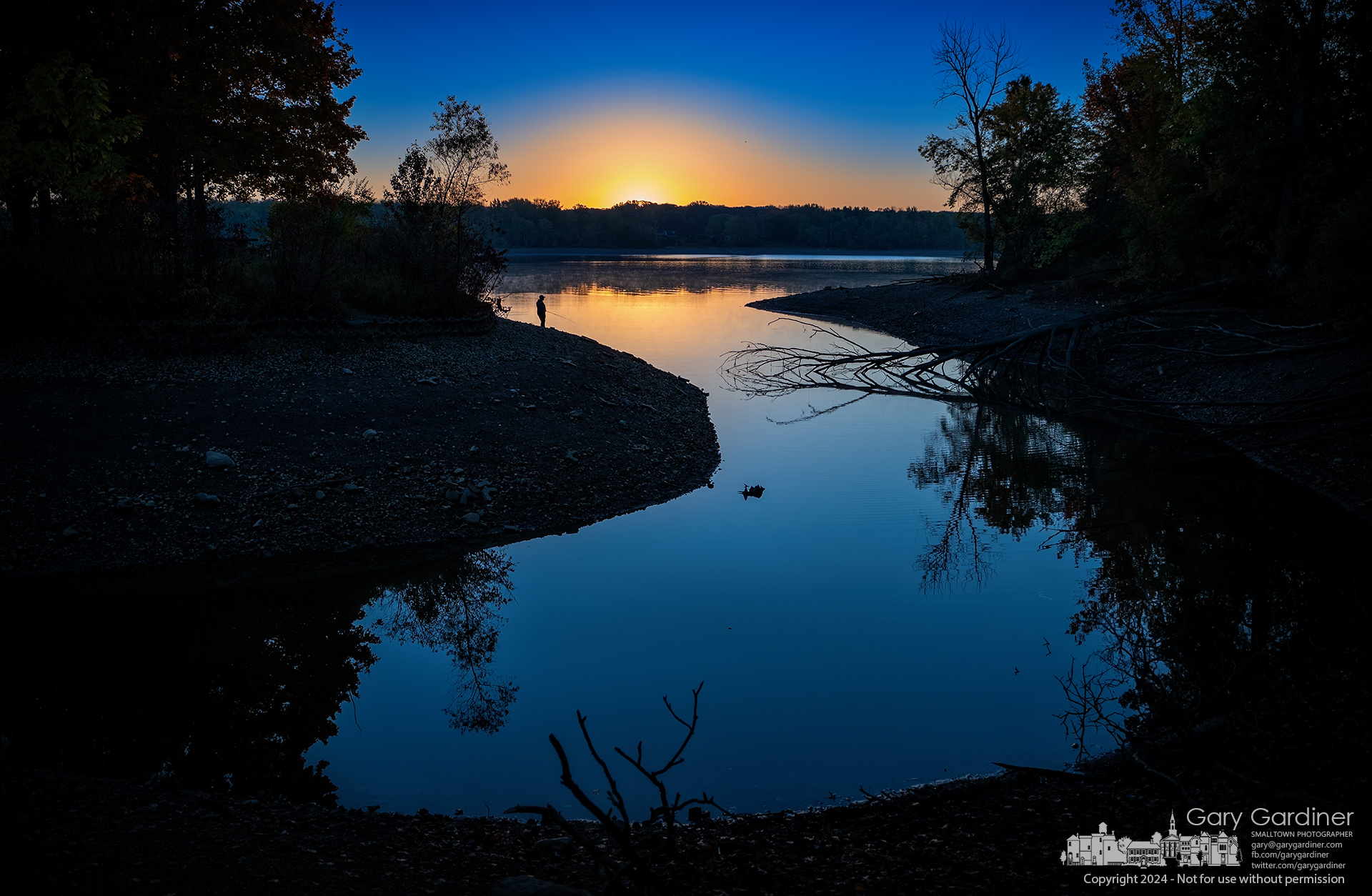 A lone fisherman stands at the edge of Hoover Reservoir just before sunrise to get an early start on a day of hopeful fishing pleasure. My Final Photo for October 21, 2024.