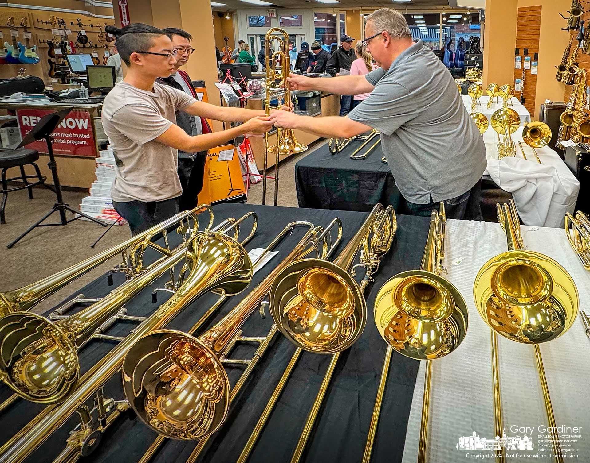 A young musician selects his new trombone from the almost 500 instruments offered at Uptown Music & Arts annual sale this weekend. My Final Photo for November 10, 2024.