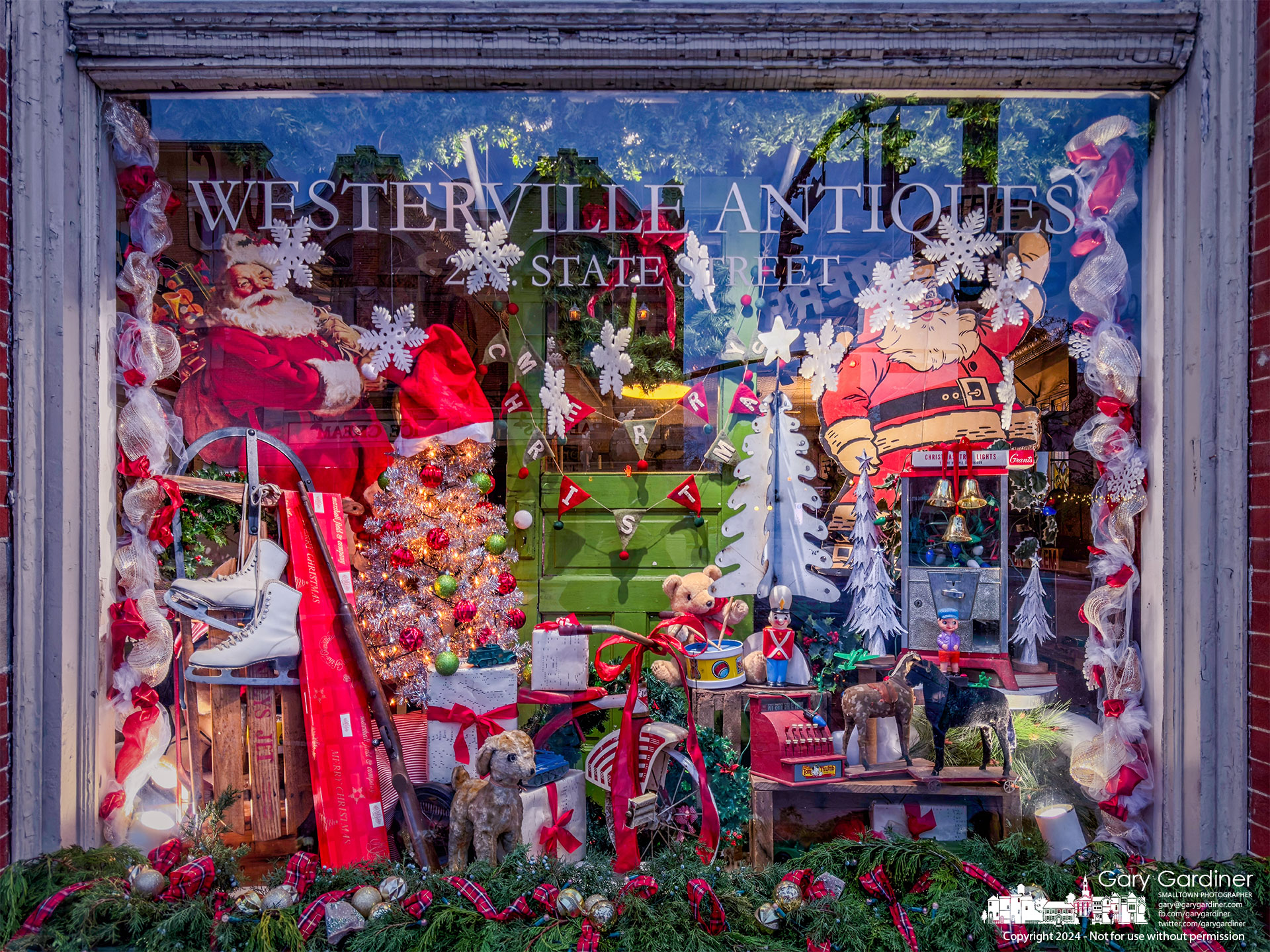 The front window of Westerville Antiques shines bright with its Christmas decorations as the sun sets on a cloudy, cool Thanksgiving Day. My Final Photo for November 28, 2024.