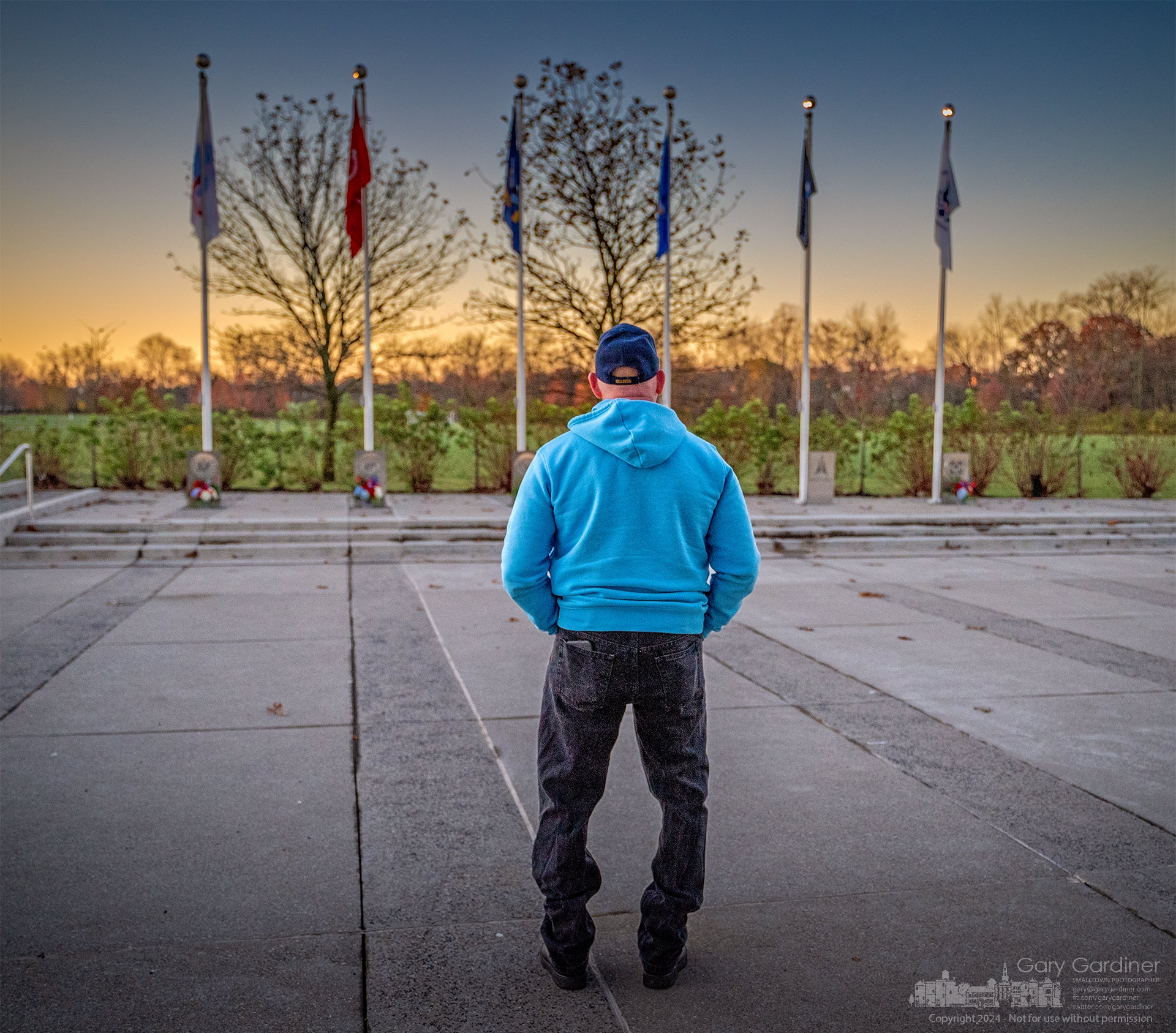 A US Navy Seabee pauses at the flagpoles and wreaths after ceremonies marking Veterans Day at the Westerville Veterans Memorial. My Final Photo for November 11, 2024.