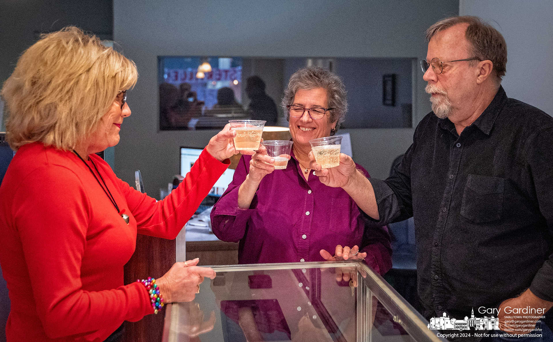 Bill and Shelley Morgan share champagne with Carida McCalla, left, over the nearly empty counter of Morgan's Treasures in Uptown, where McCall was the jeweler's first customer in his three stores in Westerville. The jeweler is retiring after 38 years of making custom jewelry. My Final Photo for December 24, 2024.