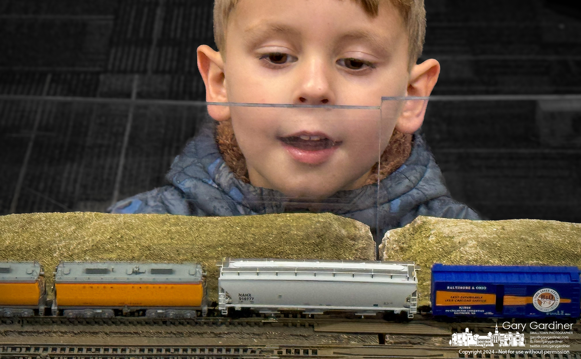 Four-year-old Ira studies the movement of "N" scale trains making the rounds in a display at the Westerville Public Library, where the Columbus Area “N” Scalers set up its annual display. My Final Photo for December 9, 2024.