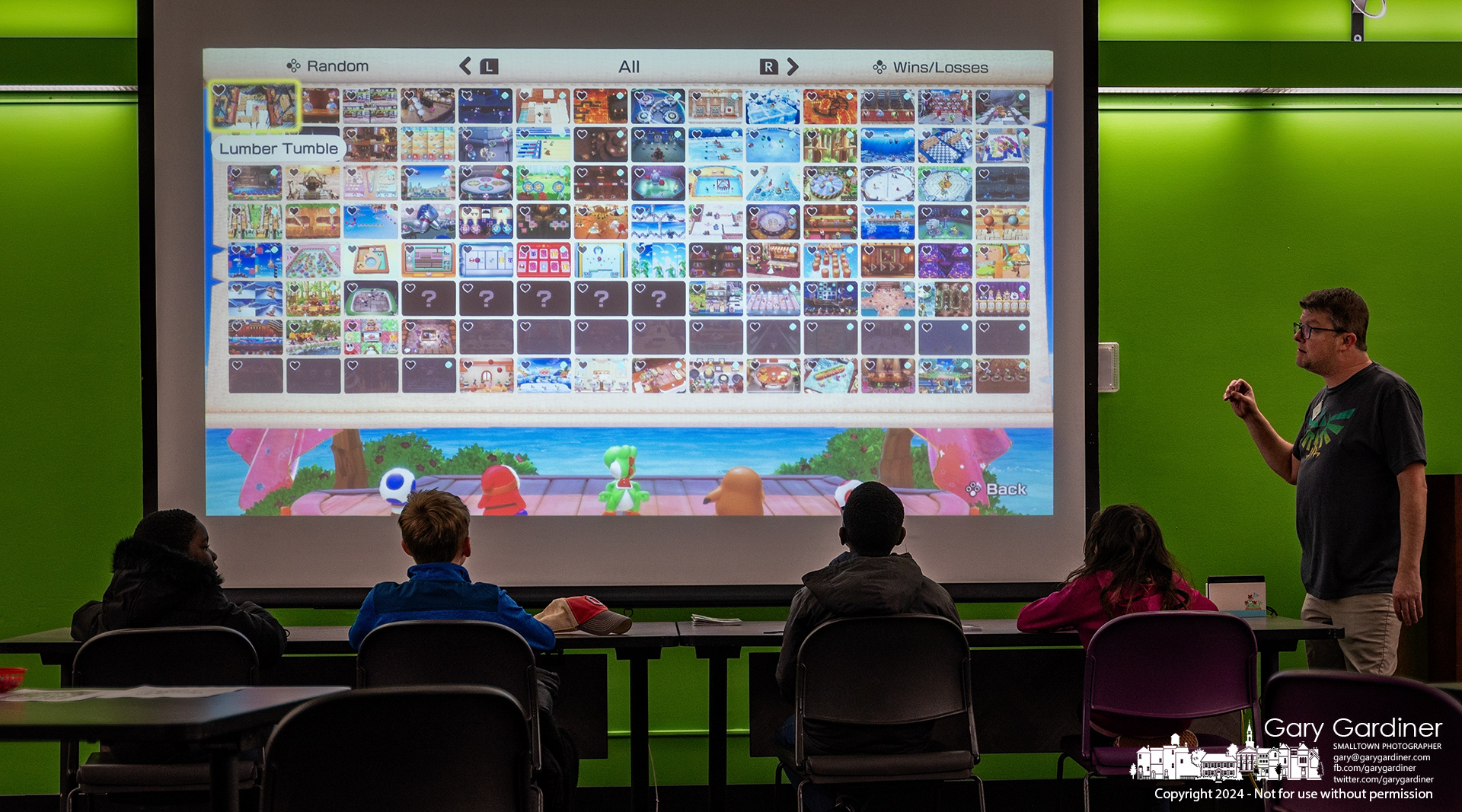 Westerville Youth Services Librarian Matt G. explains a new video game interface to four of the youngsters who gathered for Power Up Video Game Night at the library, where four players at a time quickly adapted to the four-player game before switching places with other players waiting for their turn. My Final Photo for December 4, 2024.