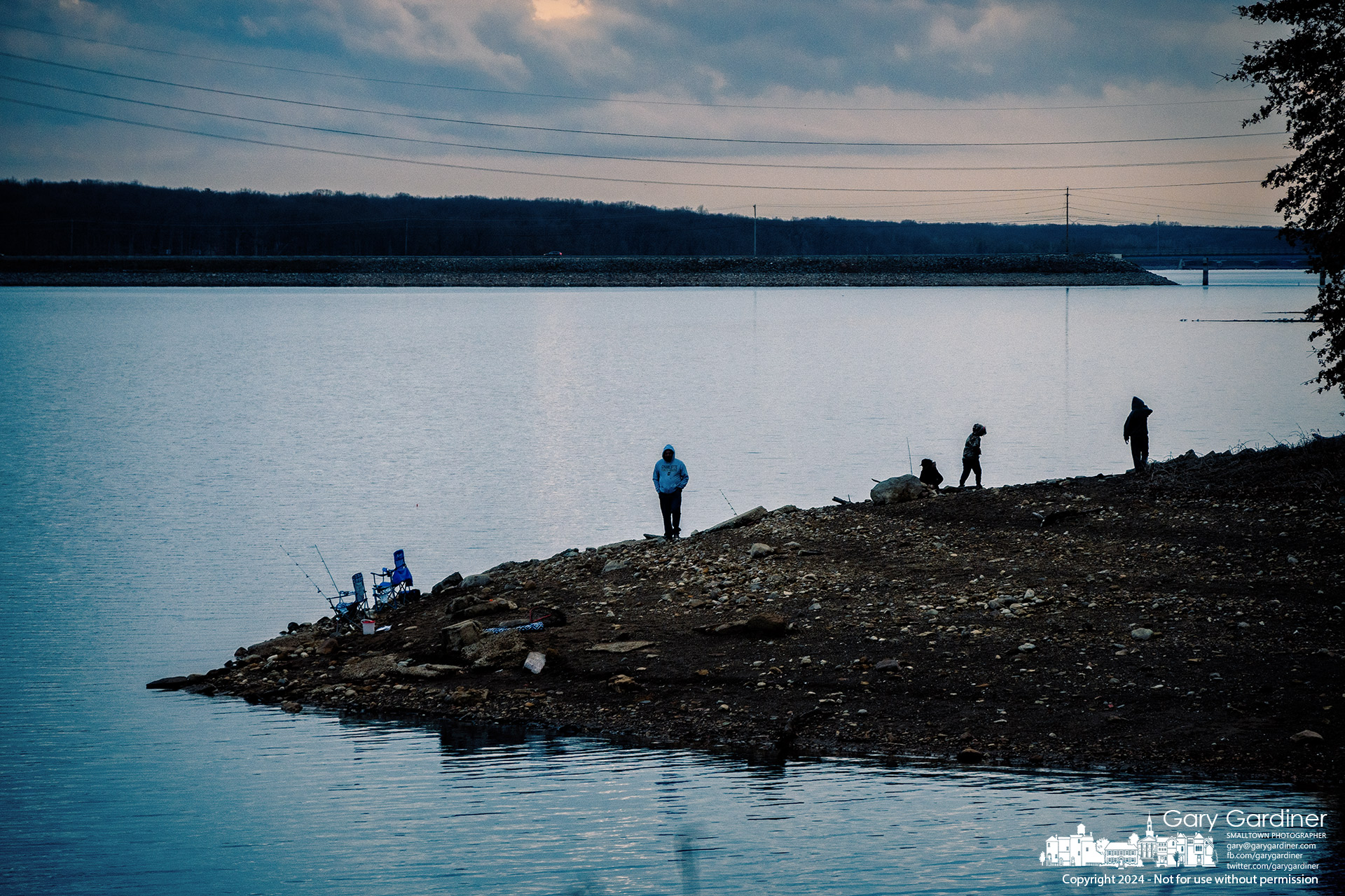 A family of five fishes and plays on the widened shoreline of Hoover Reservoir at Red Bank Park, enjoying a warm winter day on the lake with low water levels. My Final Photo for December 28, 2024.